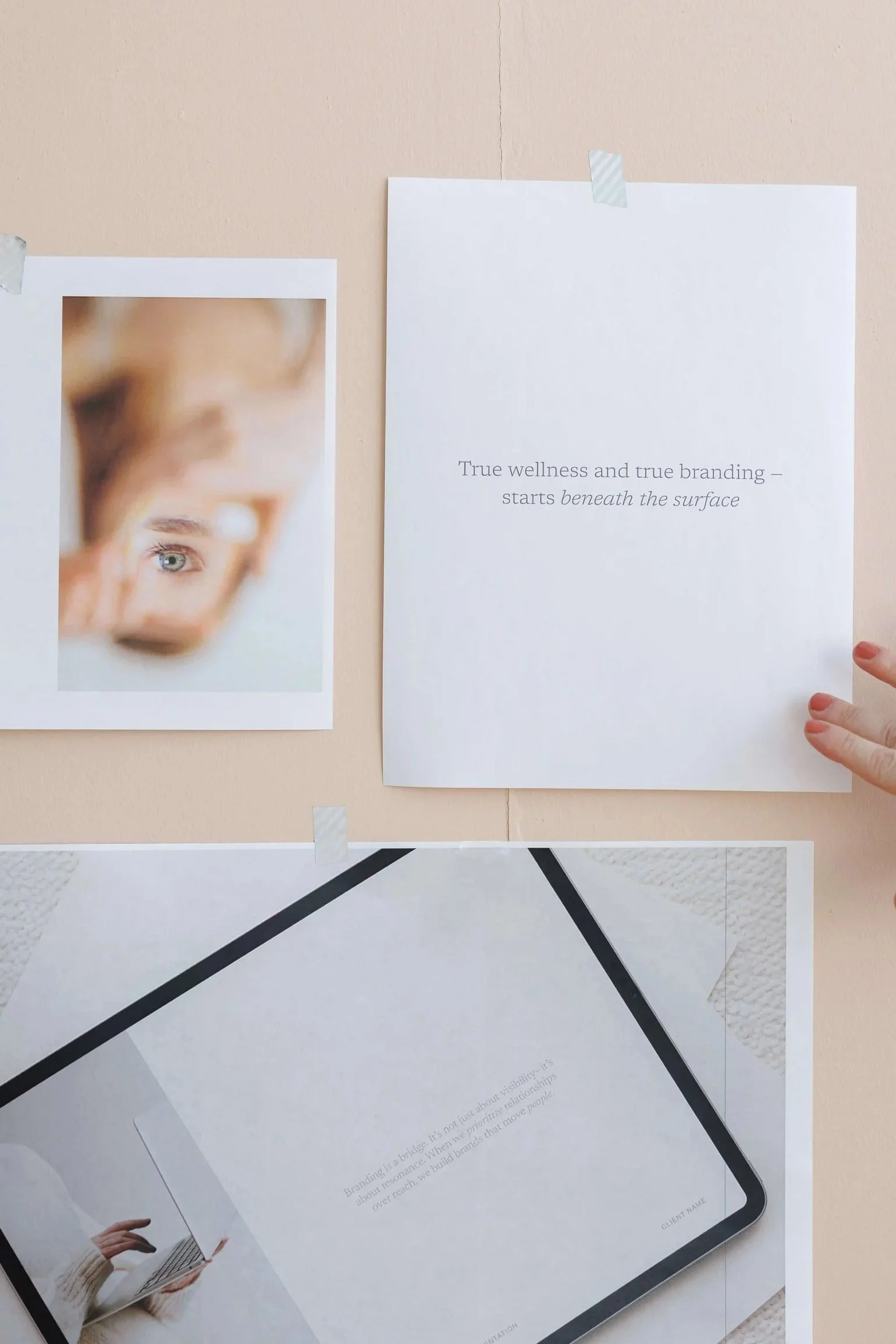 Printout with text about wellness, branding, and building brands, beside a photo of a person holding a laptop.