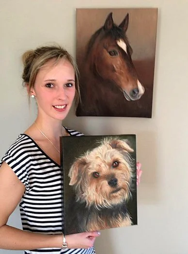 Charlie later commissioned a portrait of her terrier, “Jiffy”. Pictured here with both oil paintings.