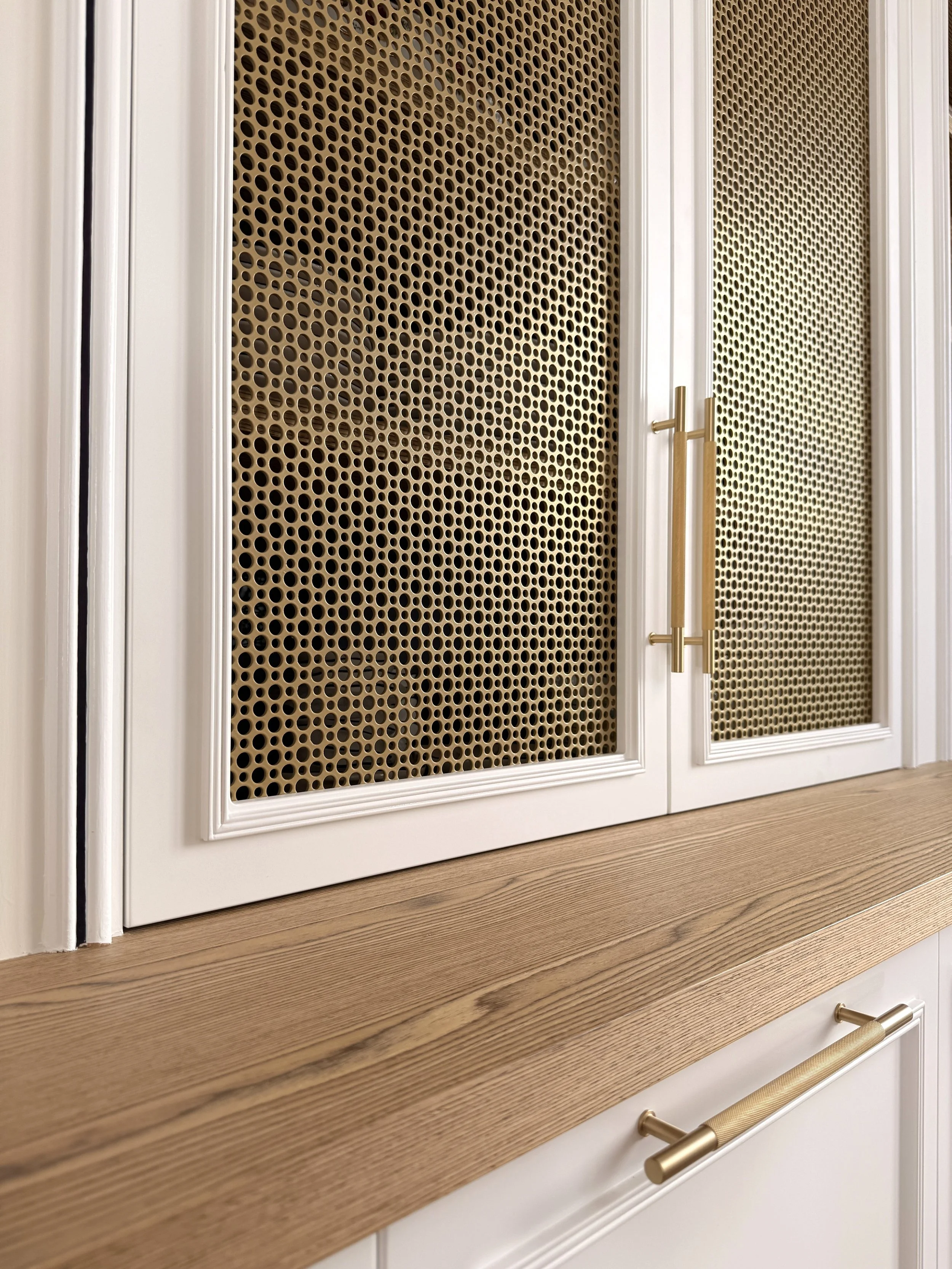 Hawthorn East Renovation Custom joinery with timber veneer 2PAC doors brass handles with knurling custom metal mesh door inlay custom moulding.JPG