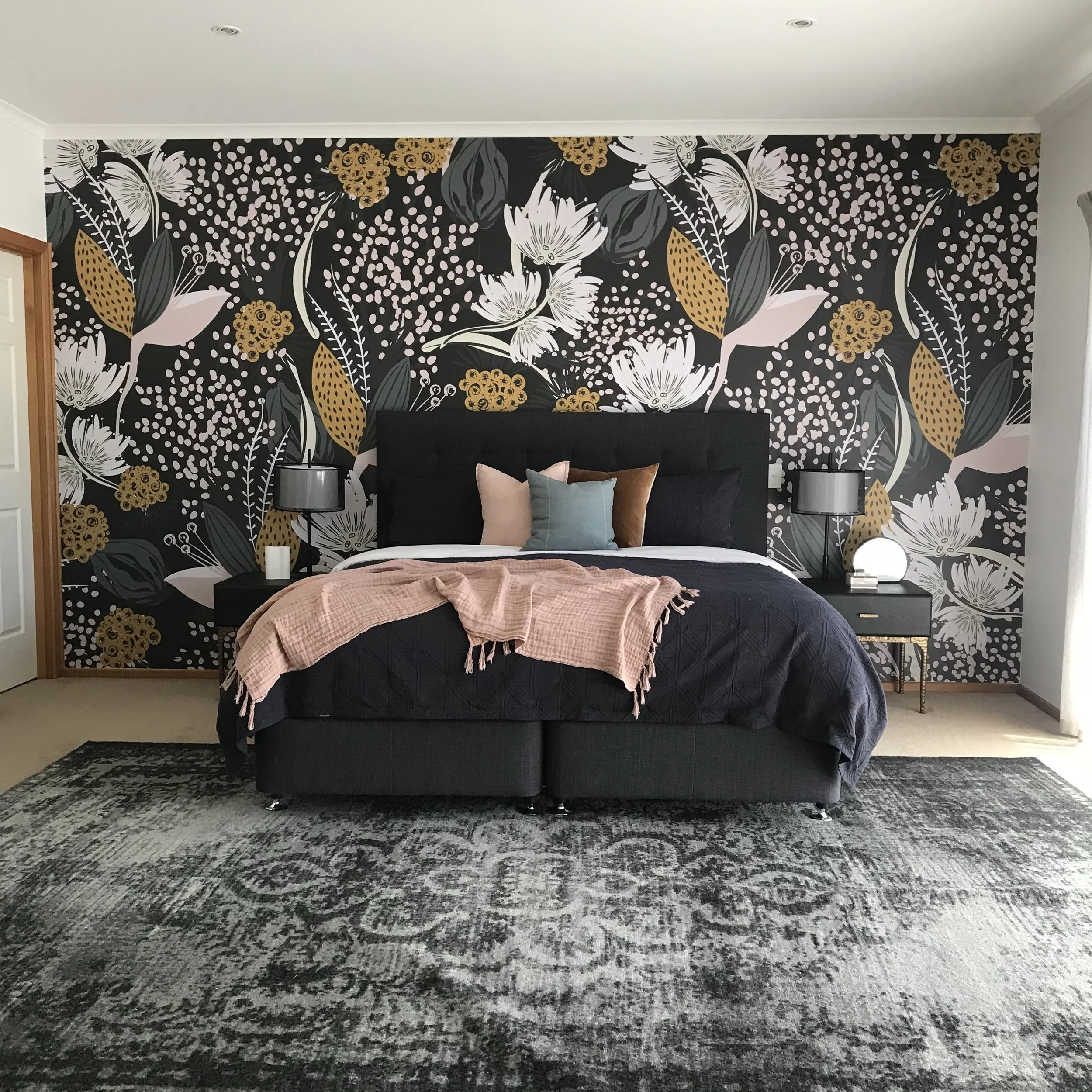 Luxury bedroom design from a full-service interior design project in Melbourne, featuring a floral accent wall and professional property styling by Storia Interiors.