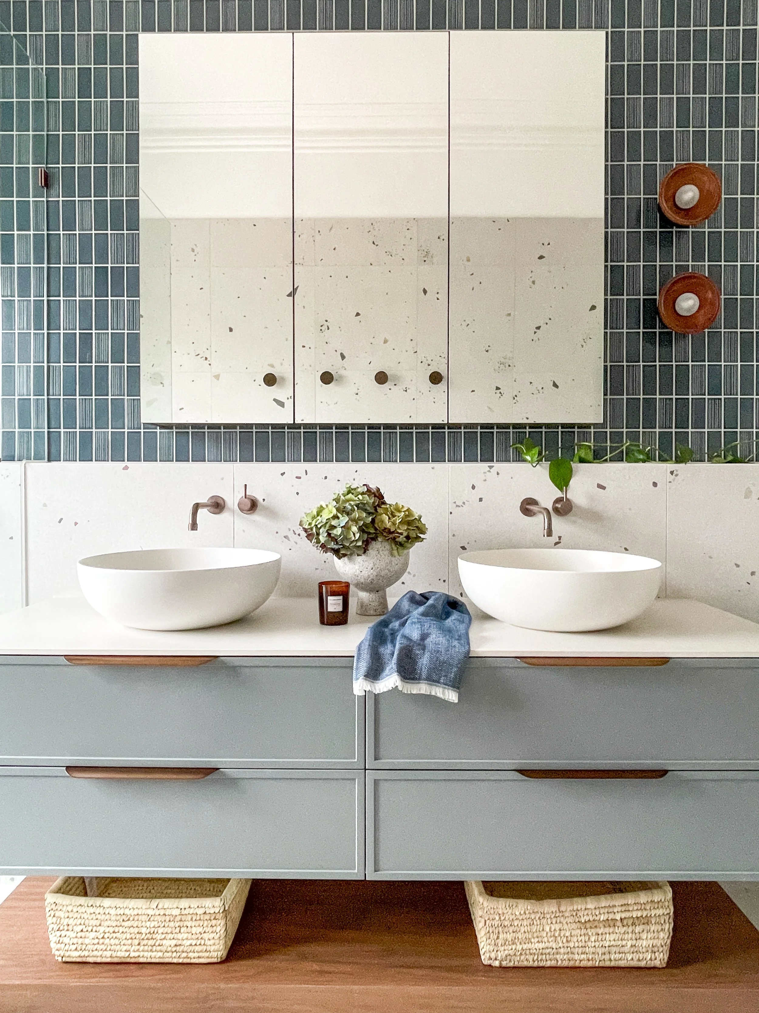 Modern bathroom in Hawthorn East featuring double basins,  terrazzo tiles, blue feature tile, and custom blue grey vanity with bronze accents.