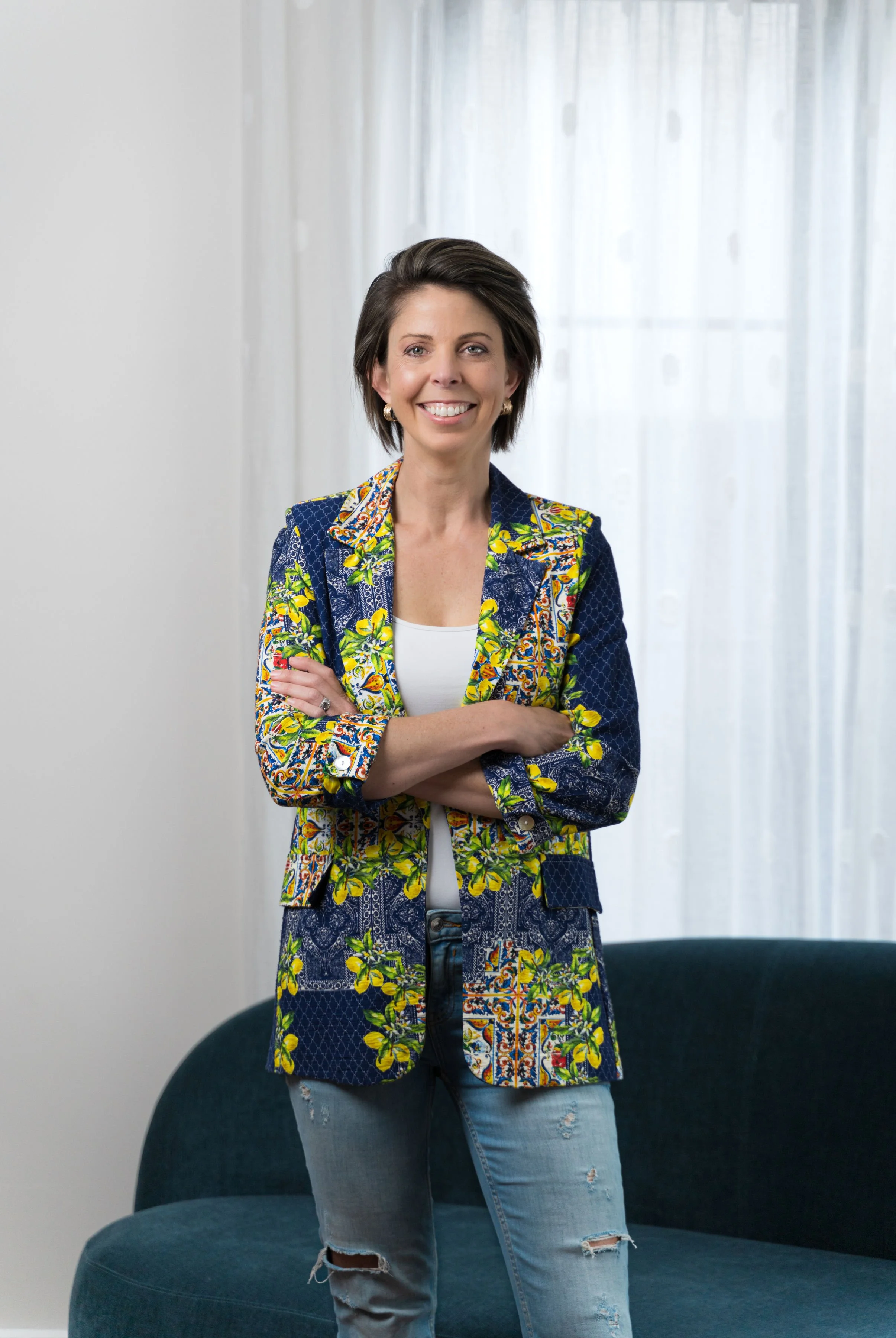 Image of Elisa Failla, Founder and Interior Designer at Storia Interiors.  Standing in living room in Hawthorn East designed by Storia Interiors