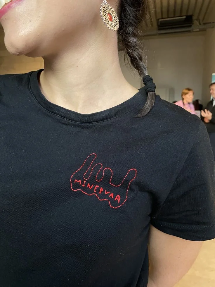hand embroided Mienrva textile tattoo on red thread.jpg