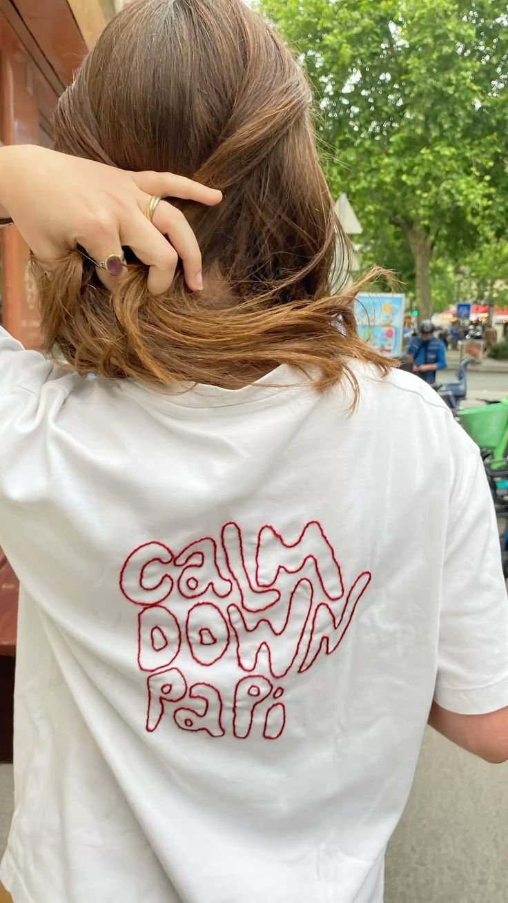 hand embroided calm down papi letters on red thread.jpg