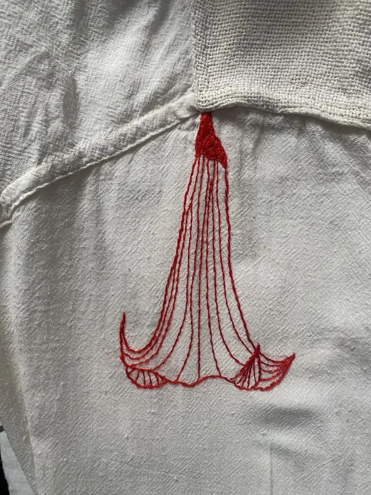 hand embroided borrachero flower on red thread (1).jpg