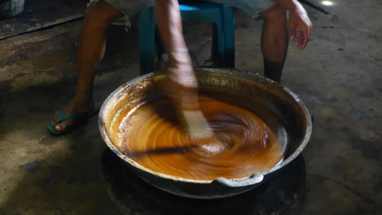 liquid palm sugar stirred in pan
