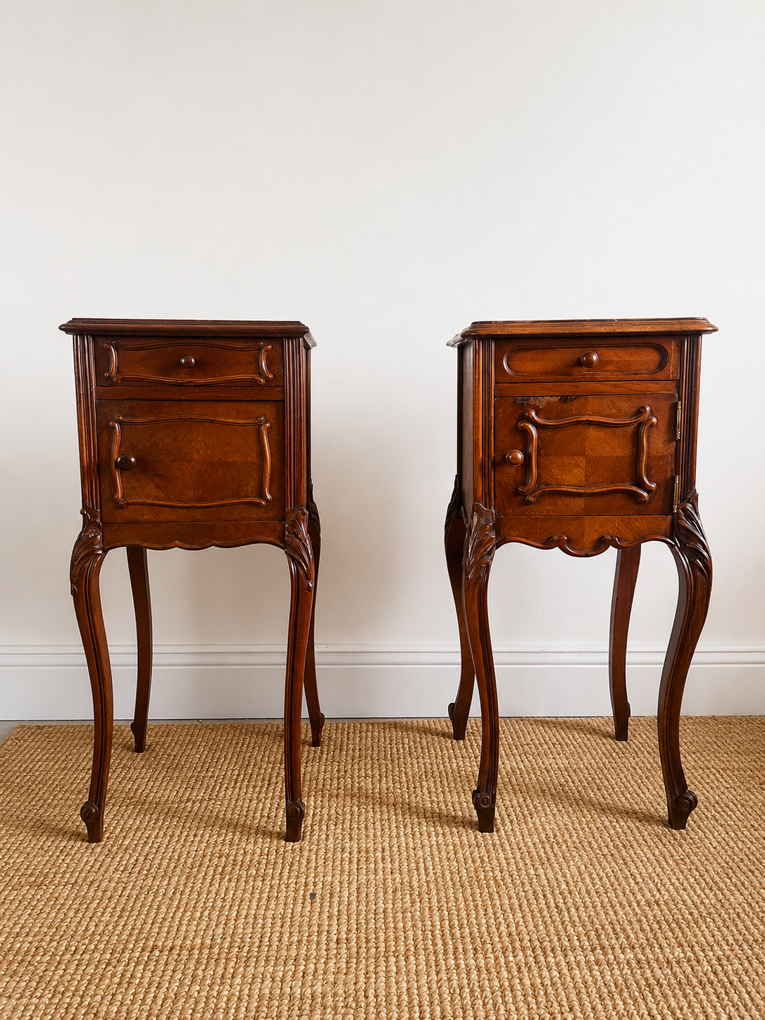 A near pair of antique French walnut and marble bedside tables