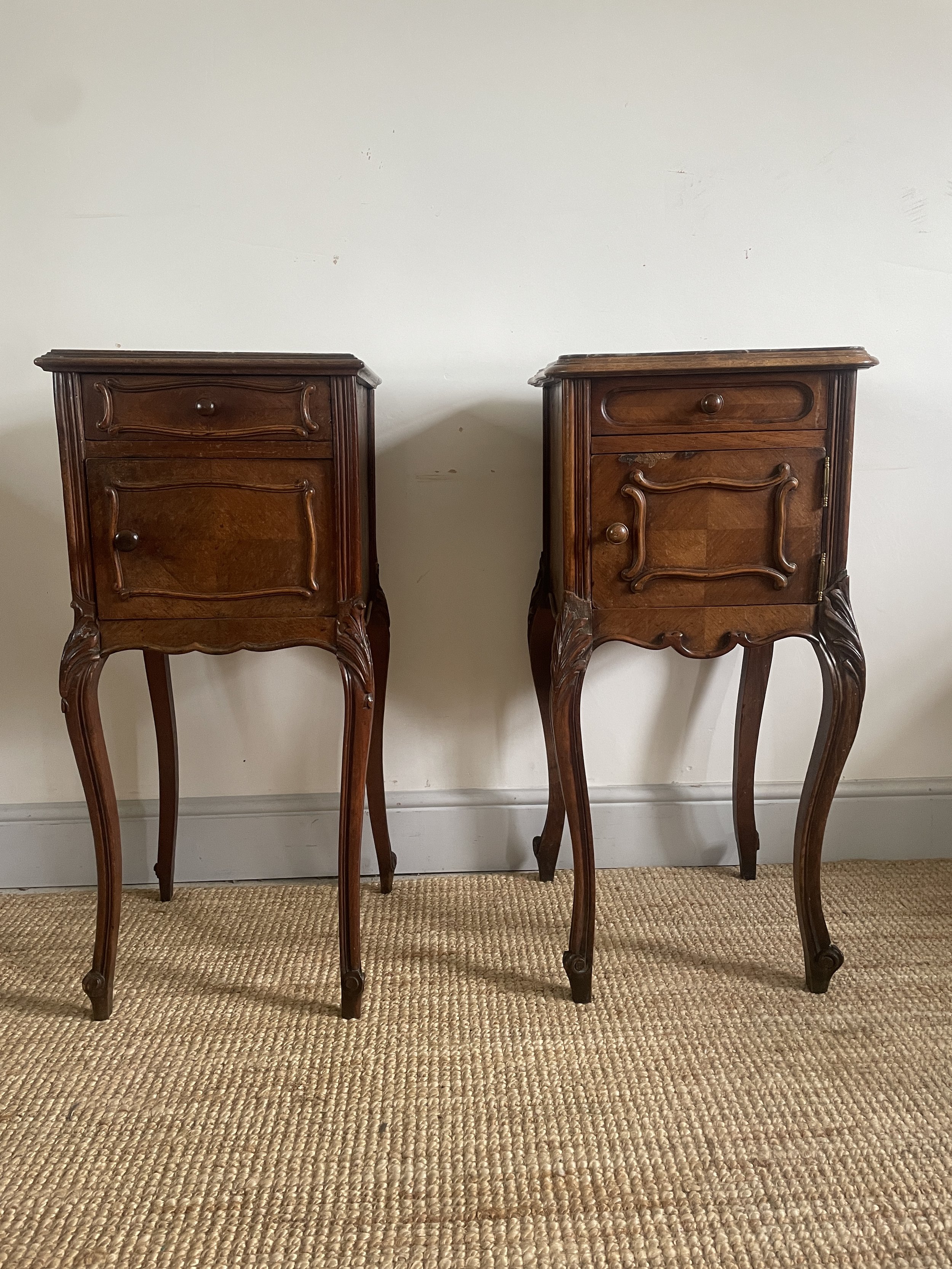A near pair of antique French walnut and marble bedside tables