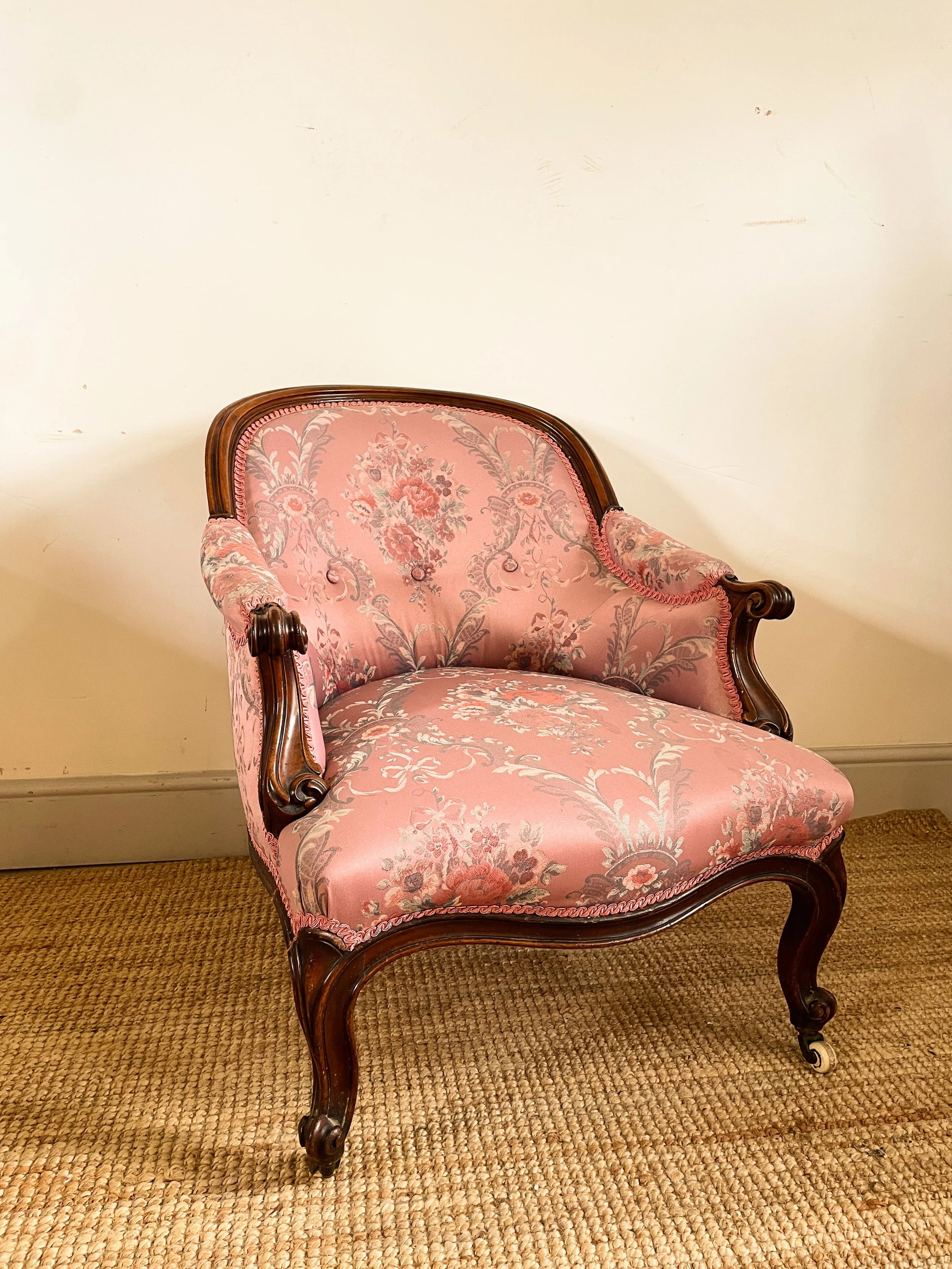 An antique French walnut bedroom armchair