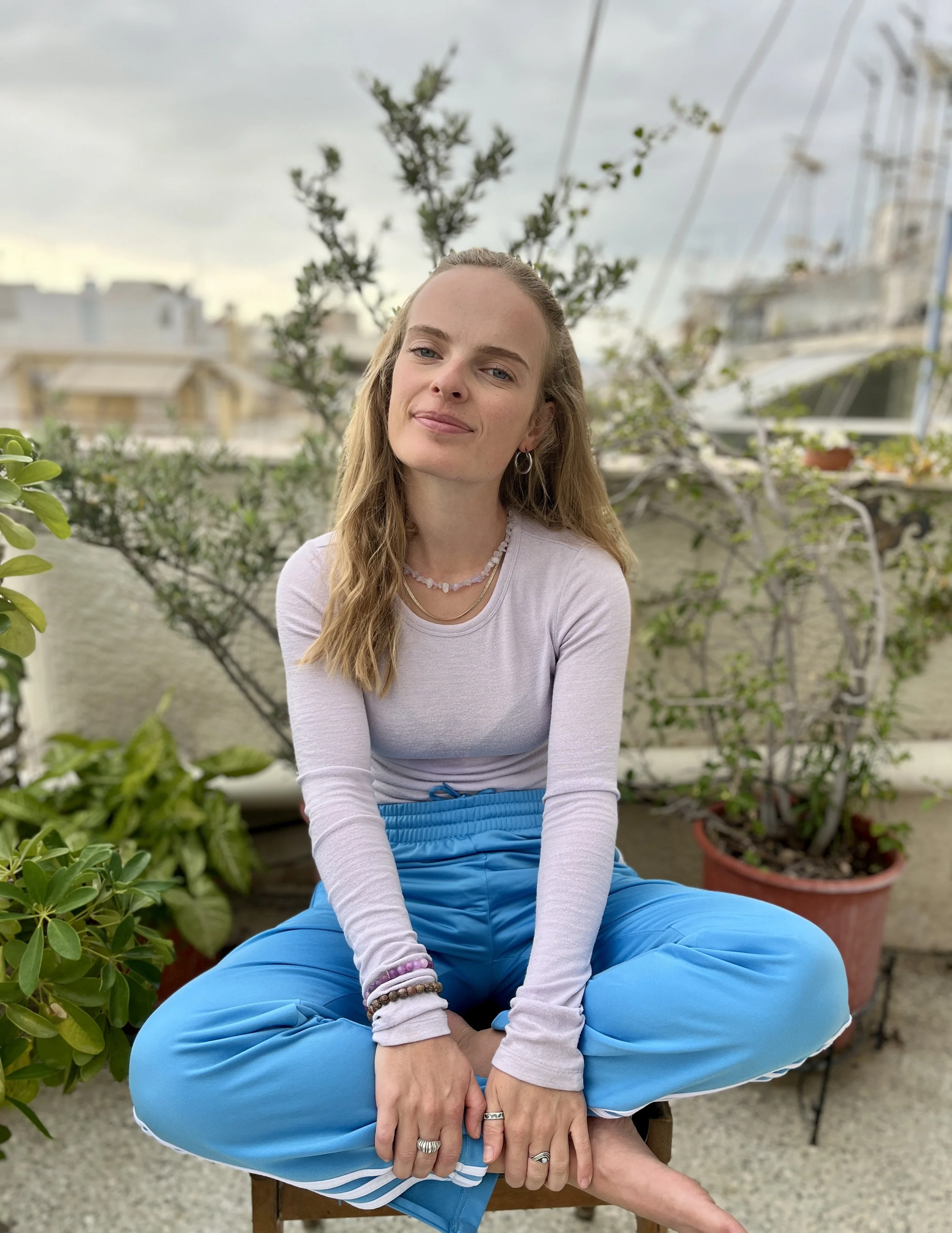 Tini sitting on a stool smiling