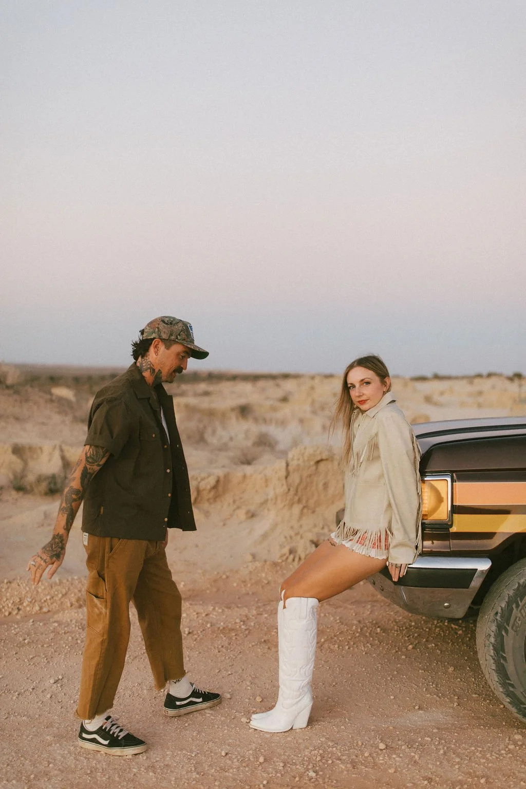 Couple photographed by Kacie Herd in a creative photoshoot at dusk