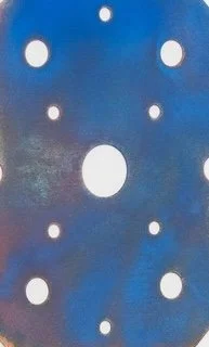 Handmade sculpture of red camouflage textiles attached to a black-and-white photocopied hand gesture, enclosed in a plexiglass box.