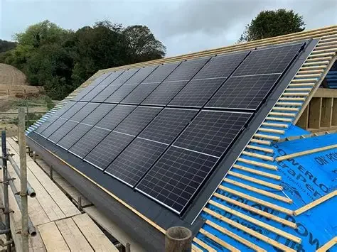 Solar panels installed on a building roof under cloudy skies.