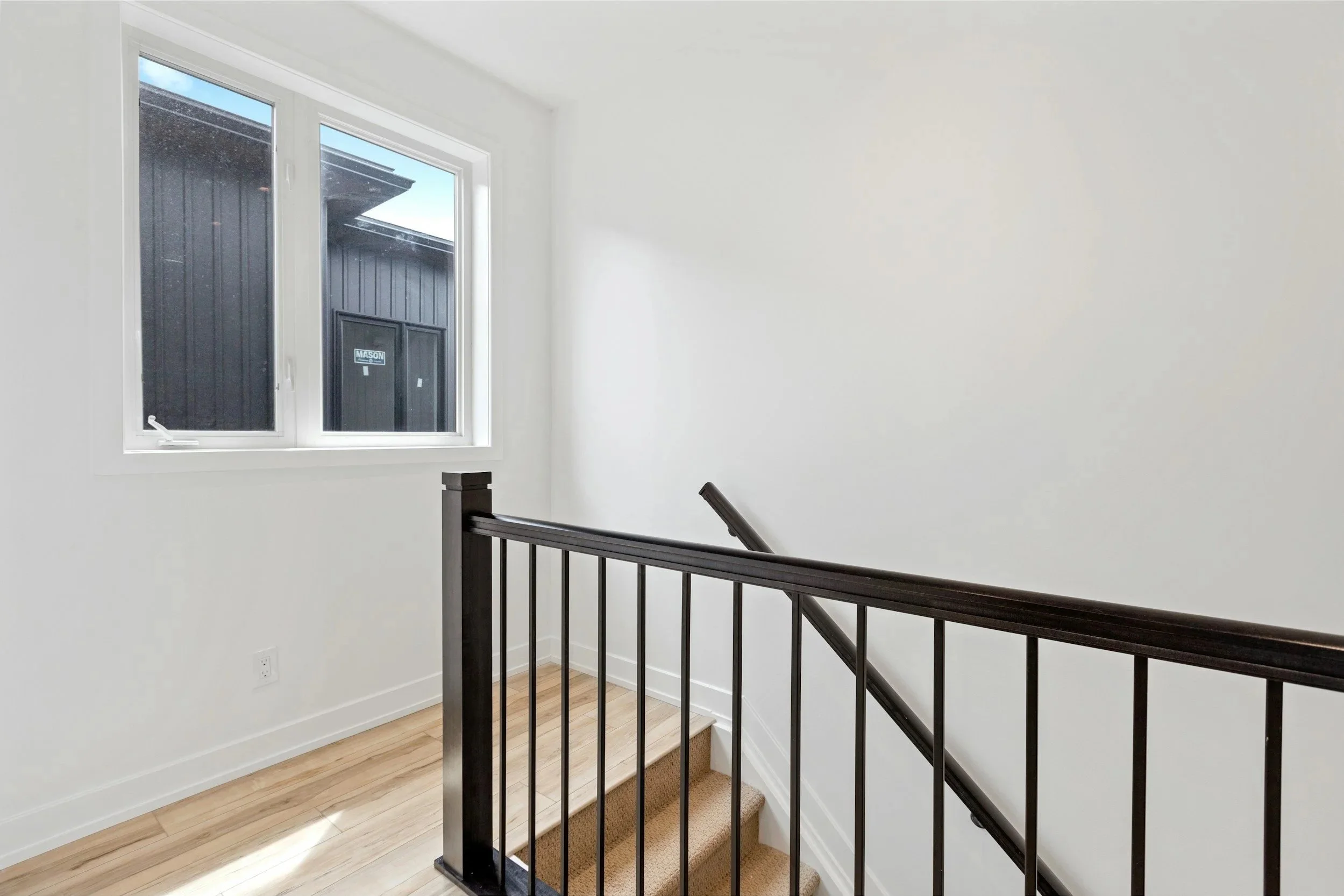 black lacquered maple wood railings with white oak floors