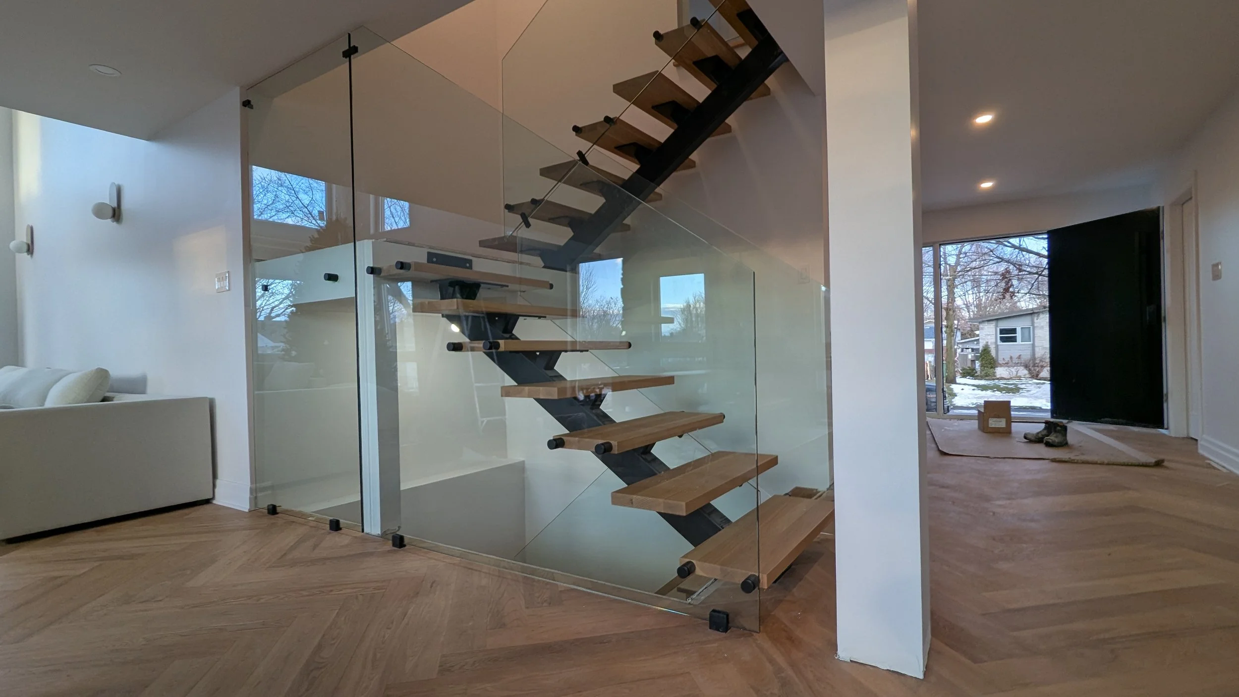 floating stairs renovation with glass panel and stand-offs railings