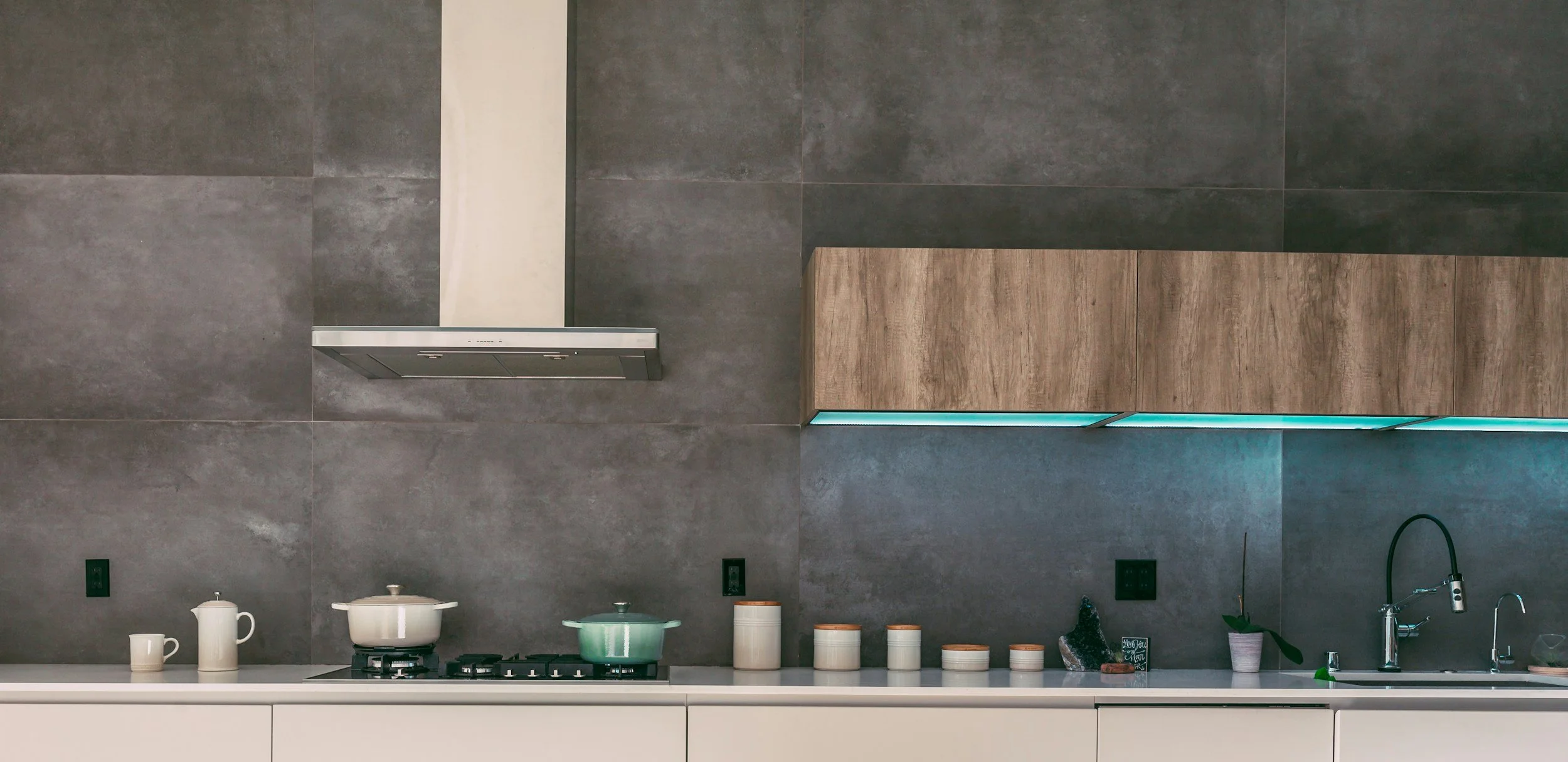 modern and minimalist kitchen renovation with concrete backsplash with oak cabinets.
