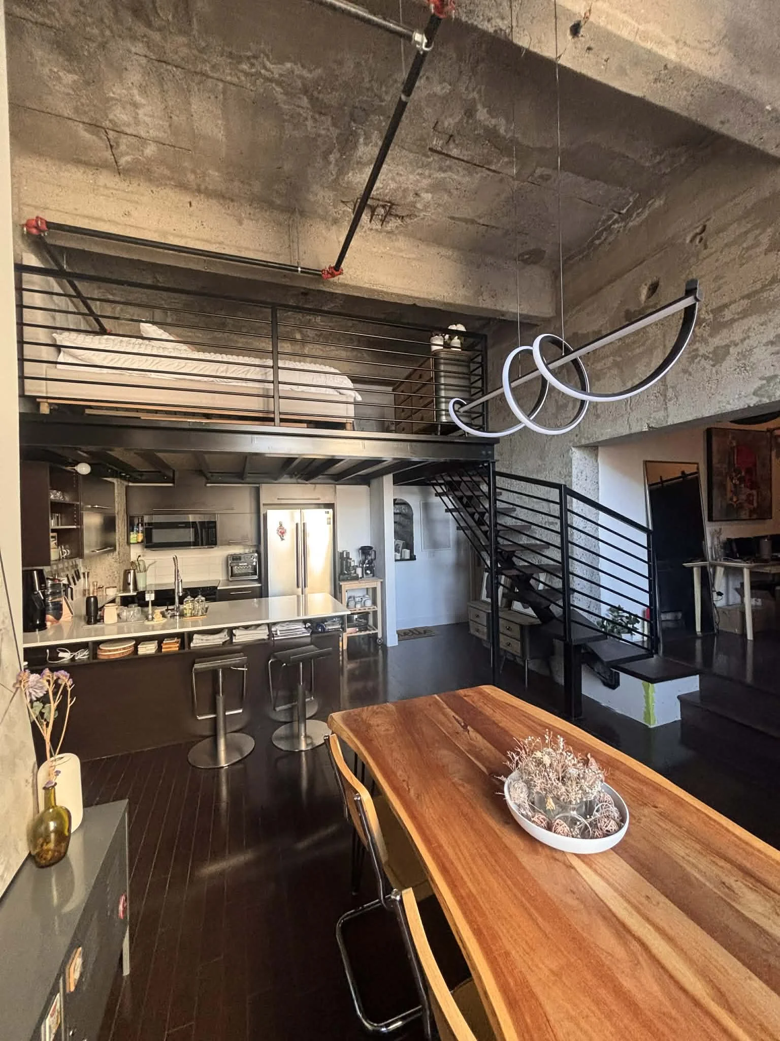 view of a condo in montreal with a new mezzanine. Steel structure with birch flooriing that matches the 1st floor existing one