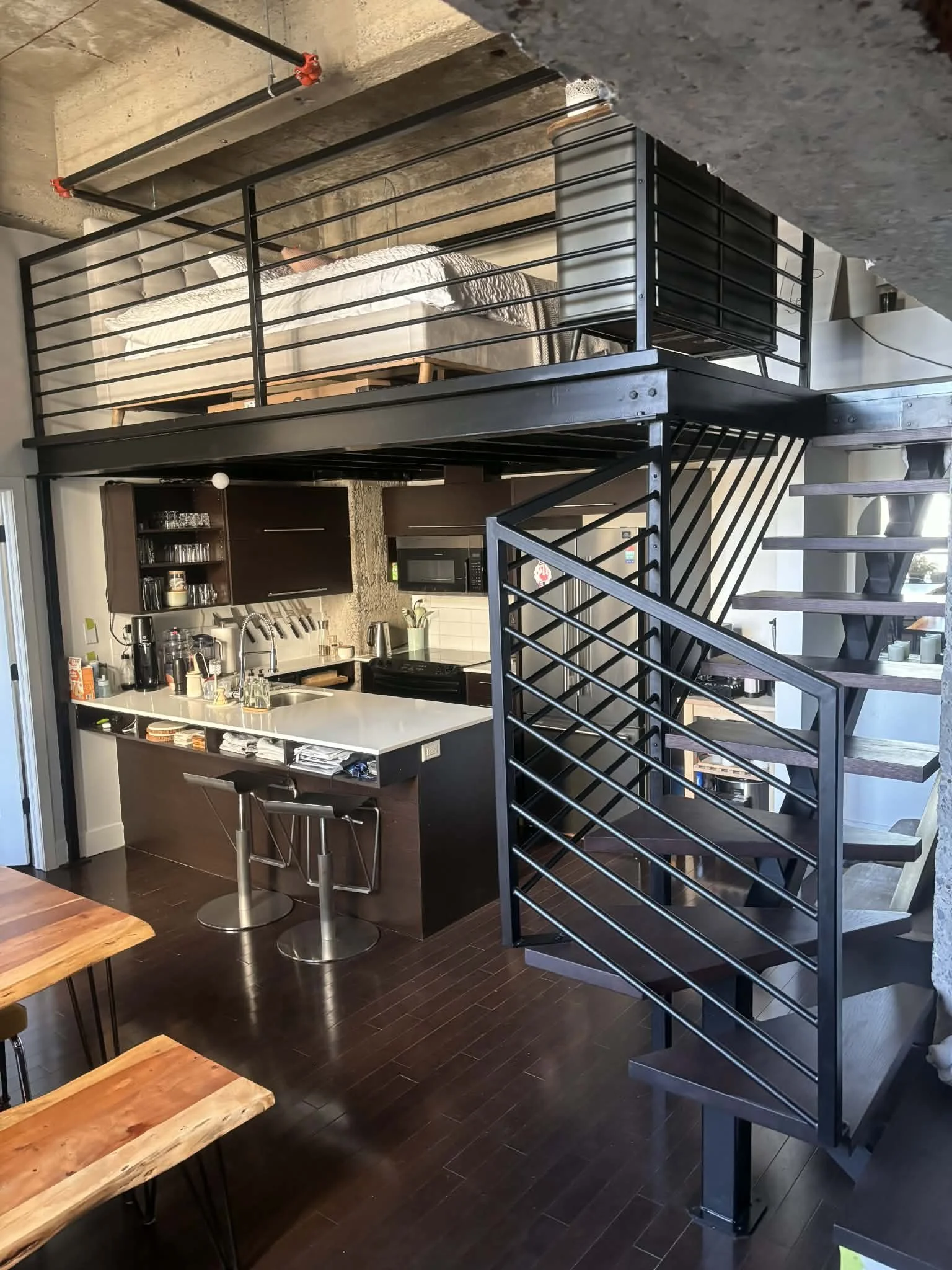 A steel structure for a mezzanine, a steel central stringer and dark birch flooring color matched to the stair treads