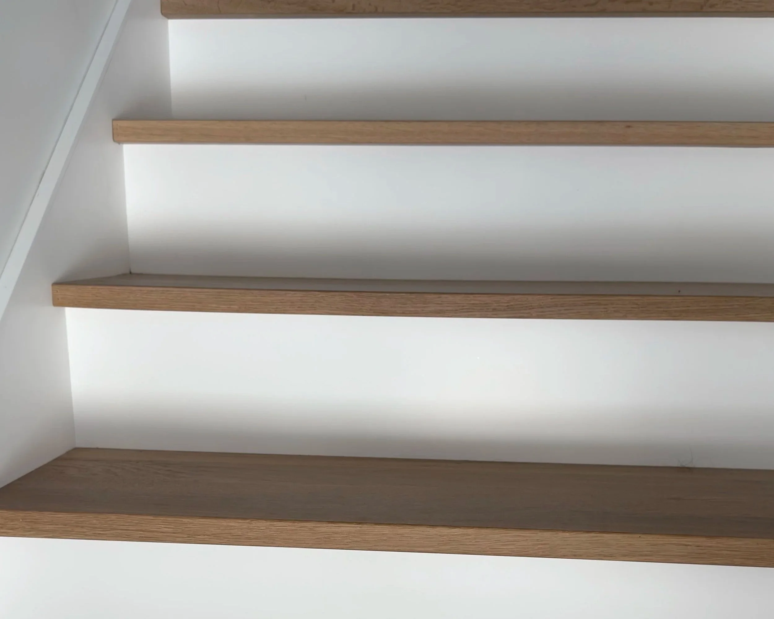white oak treads close-up with white risers and stringers