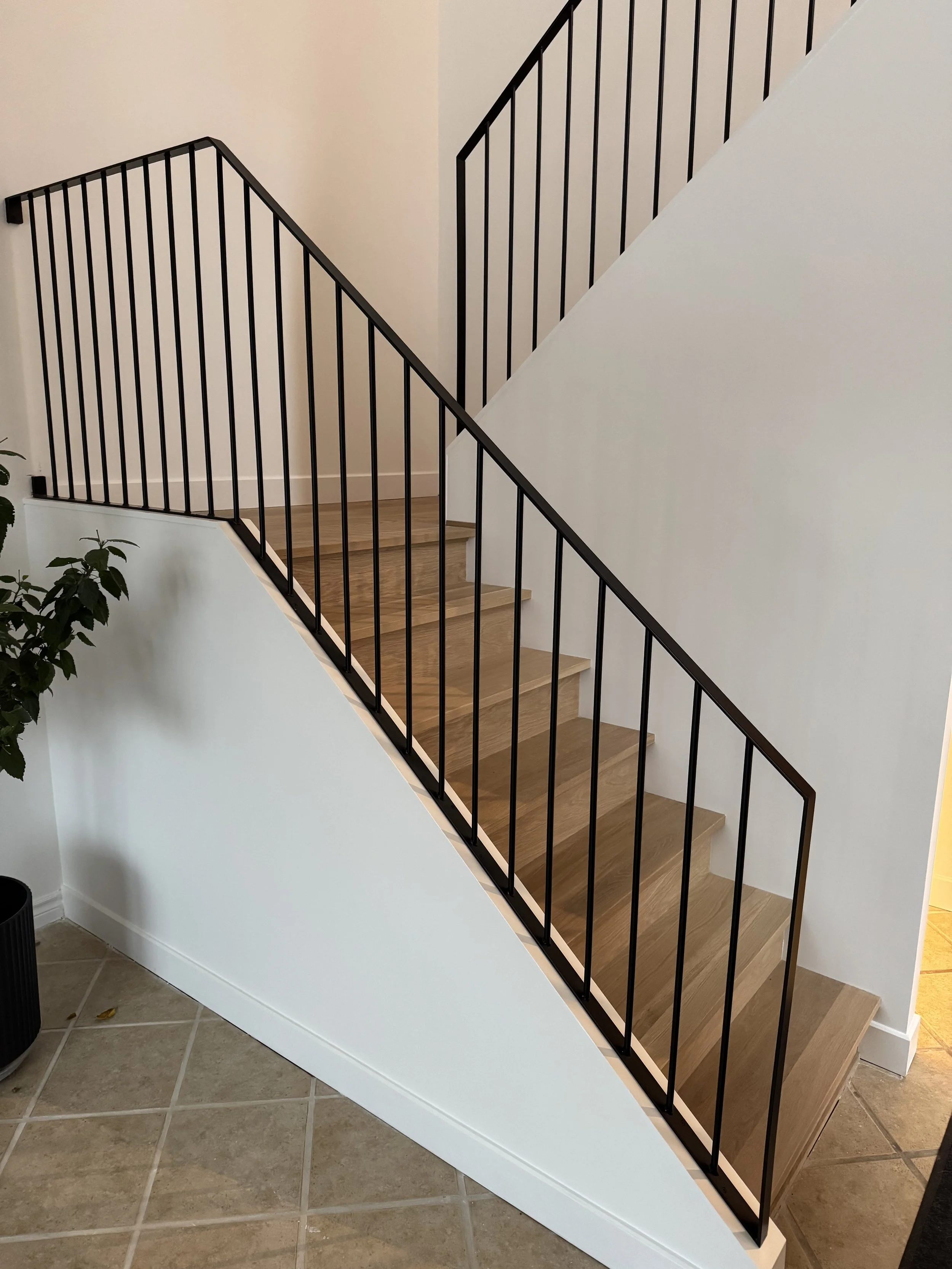 customer black steel railings and white oak stairs.