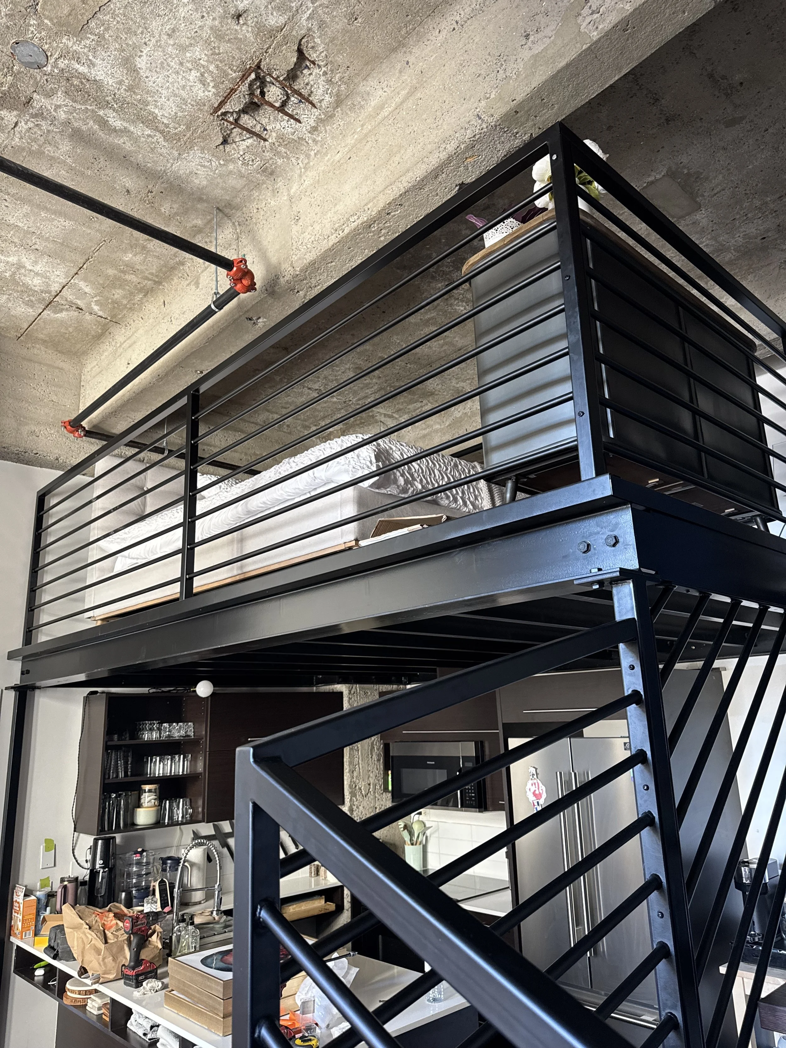 mezzanine in a condo with a central steel stringer and birch wood treads also color matched to the birch floors.