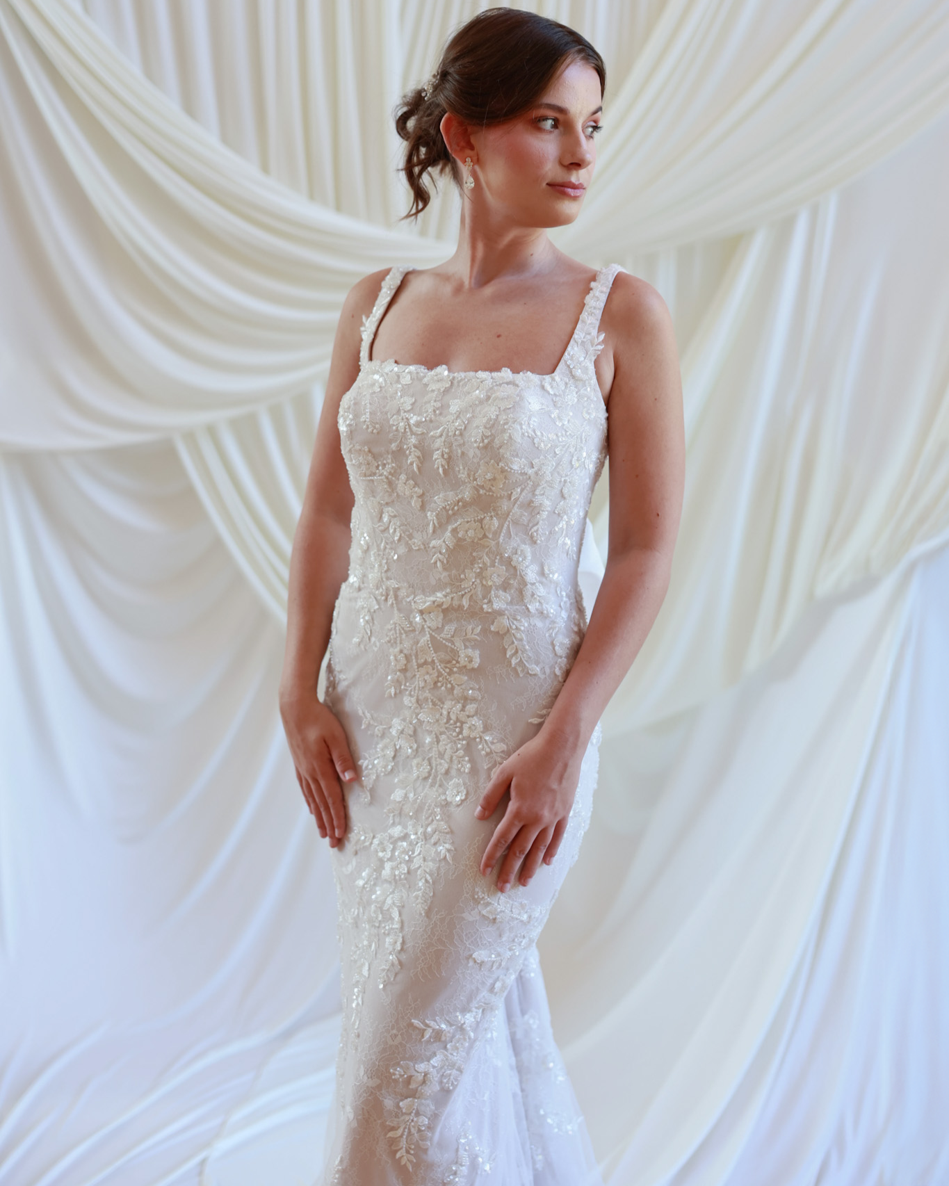 Lace wedding gown with floral appliqué and fitted silhouette