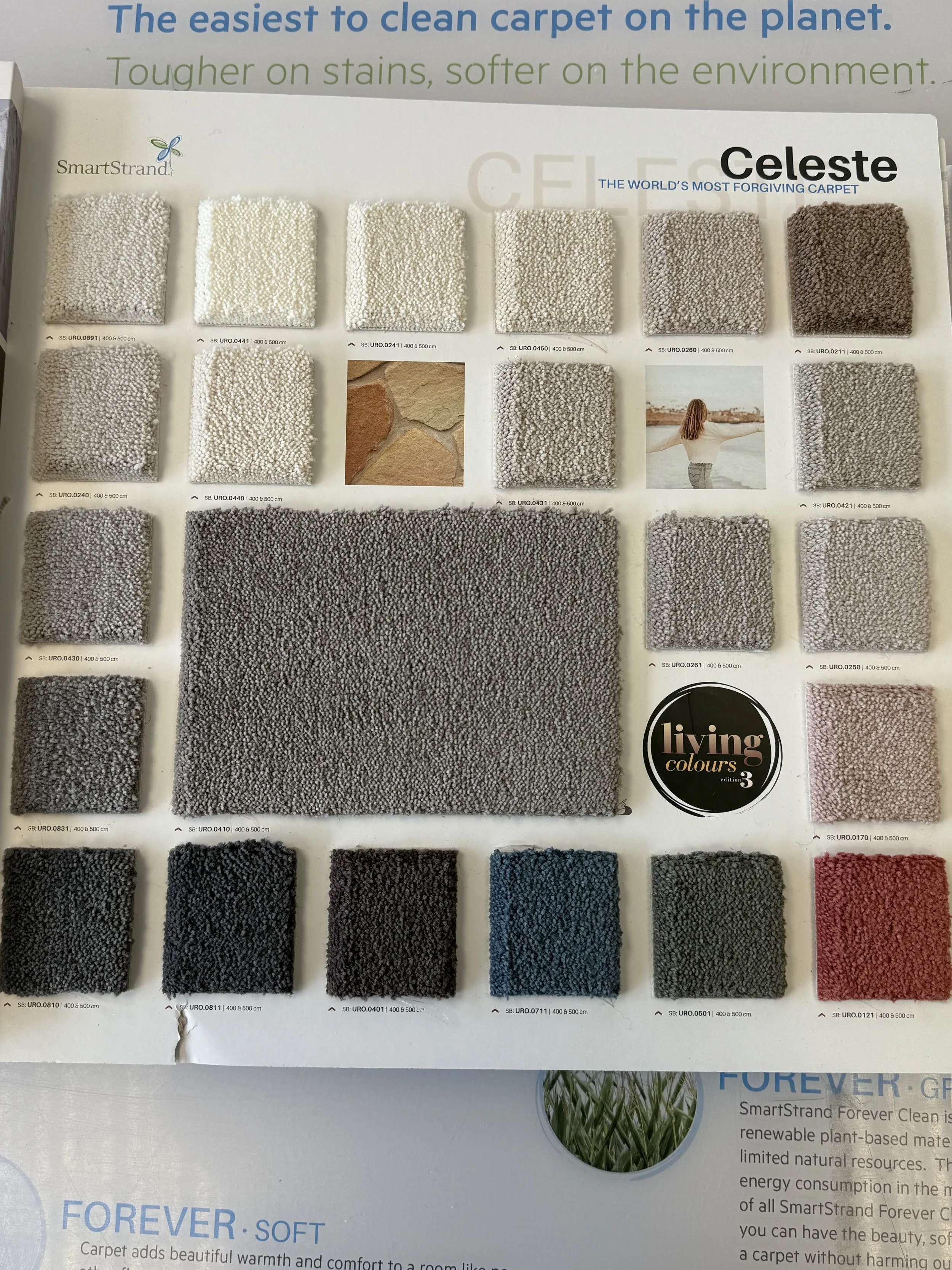 SmartStrand Carpet - Color sample swatches of different carpet textures and shades, arranged in a grid. The samples are beige, gray, black, blue, green, and red, with various textures. A small photo of a woman with outstretched arms is also included.