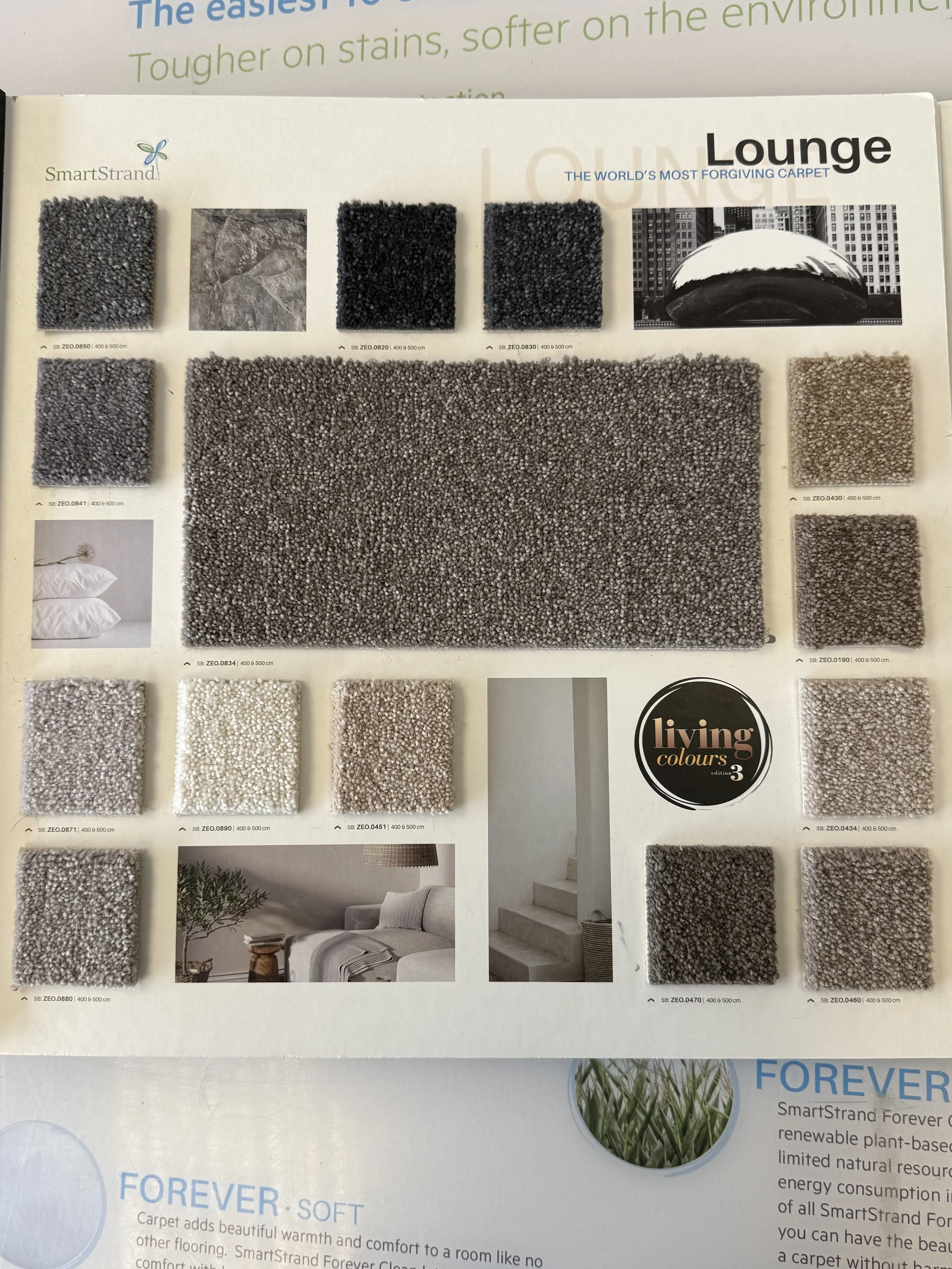 SmartStrand Carpet - Sample carpet swatches and textures in shades of gray, beige, and black displayed on a catalog page for lounge carpet styles.