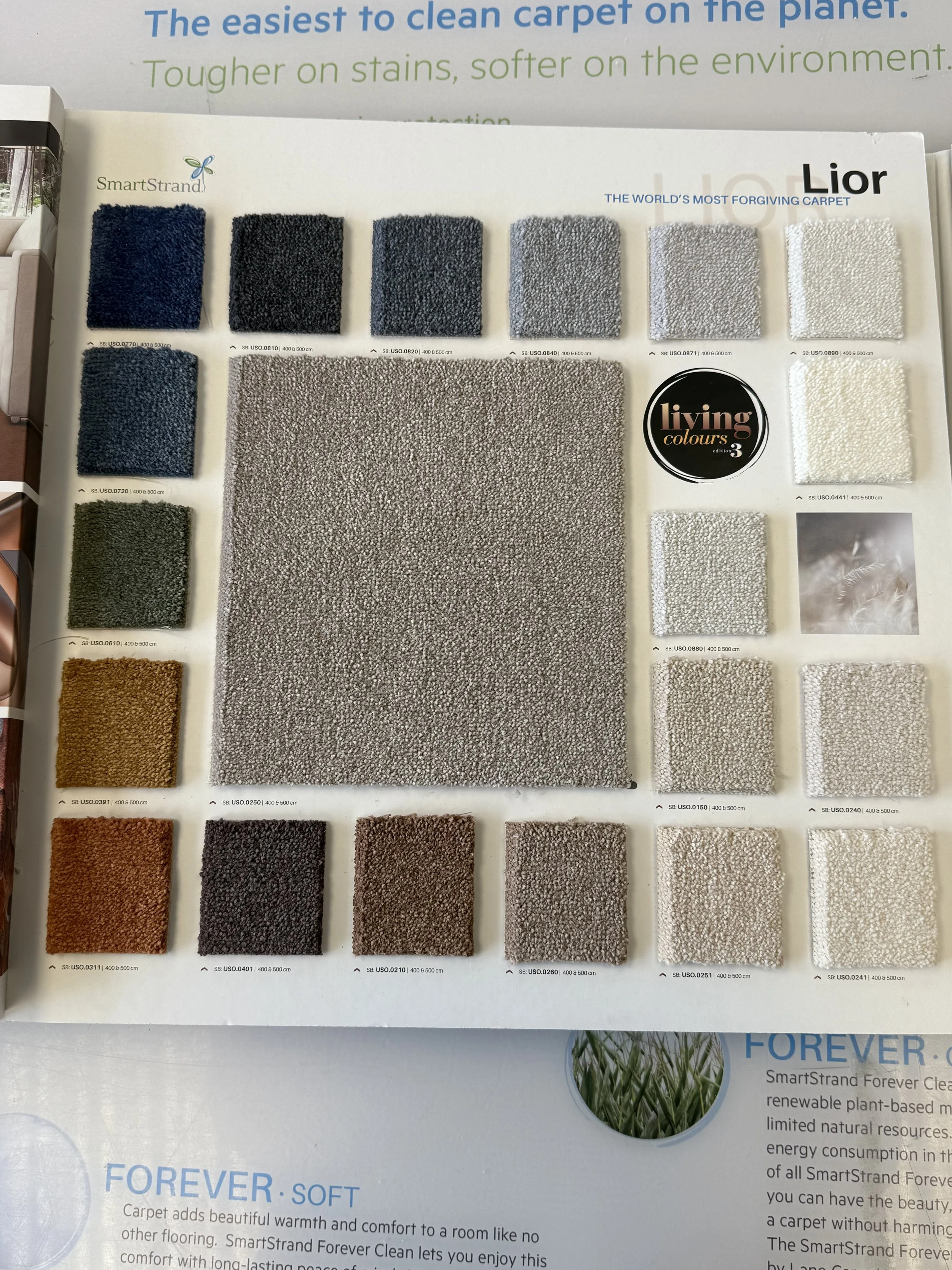 SmartStrand Carpet - A display of various carpet swatches in different colors and textures, arranged on a sample board.