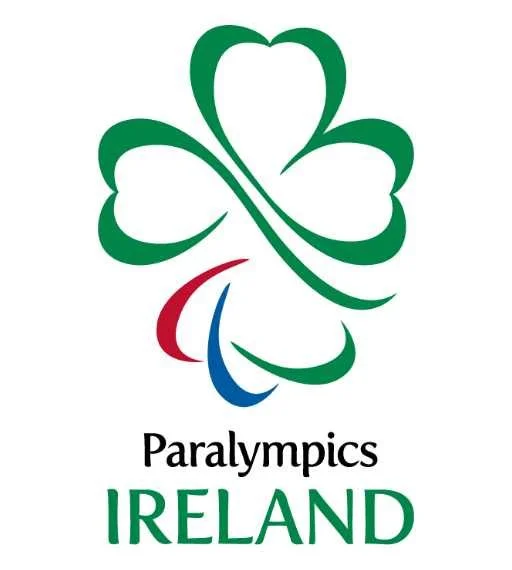 Logo of Paralympics Ireland featuring a stylized four-leaf clover with green, red, blue, and white elements, and the text "Paralympics Ireland"
