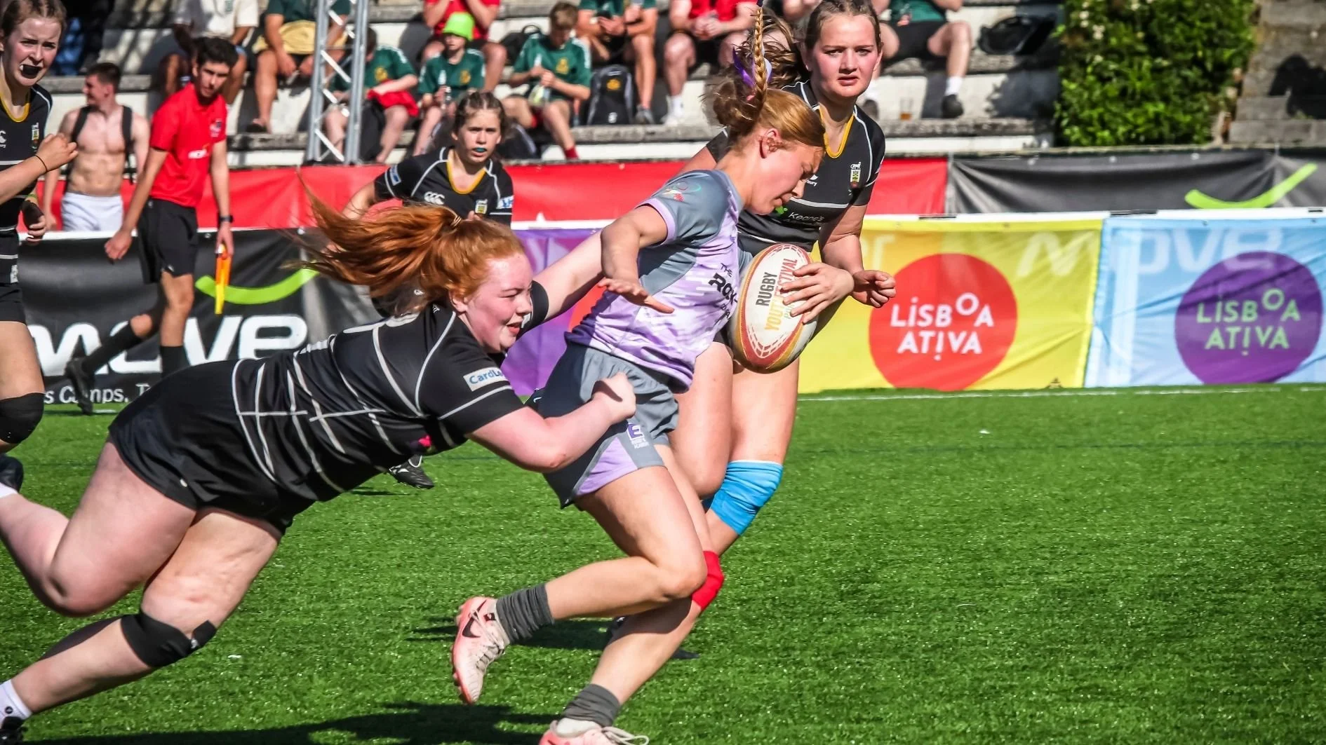 girl-rugby-player-being-tackled.jpg