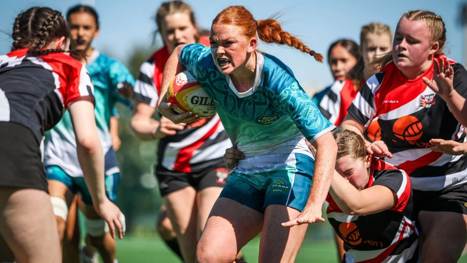 girl-rugby-player-running-and-holding-the-ball.jpg