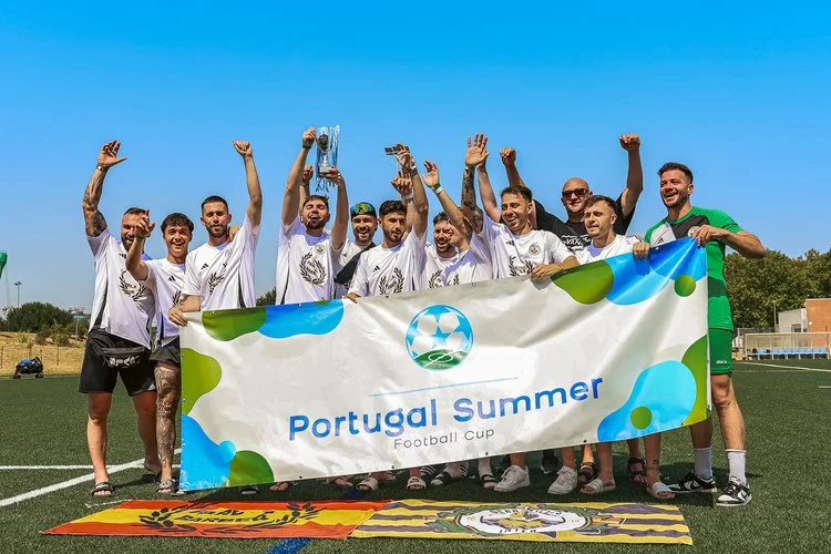 Football team celebrating with the trophy after winning the Portugal Summer Football Cup 2025.
