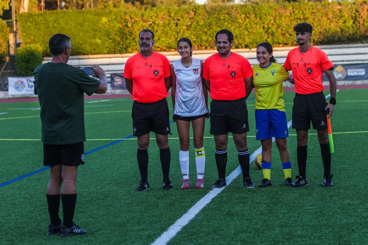 Match officials and team captains posing for a pre-match photo during the Lisbon Football Youth Cup 2025.