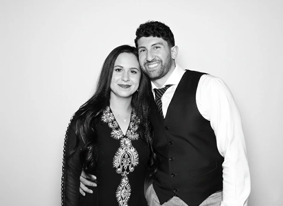 Couple takes photo in a glam Photo Booth rental offered by exp photo