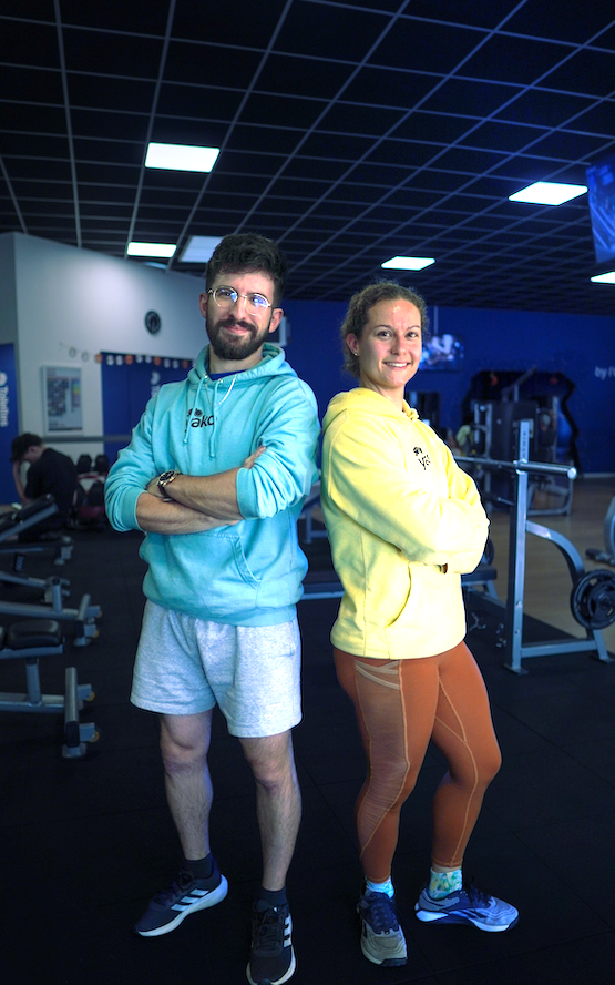 Three young adults standing against an orange background, wearing casual and athletic clothing, with arms crossed and smiling.