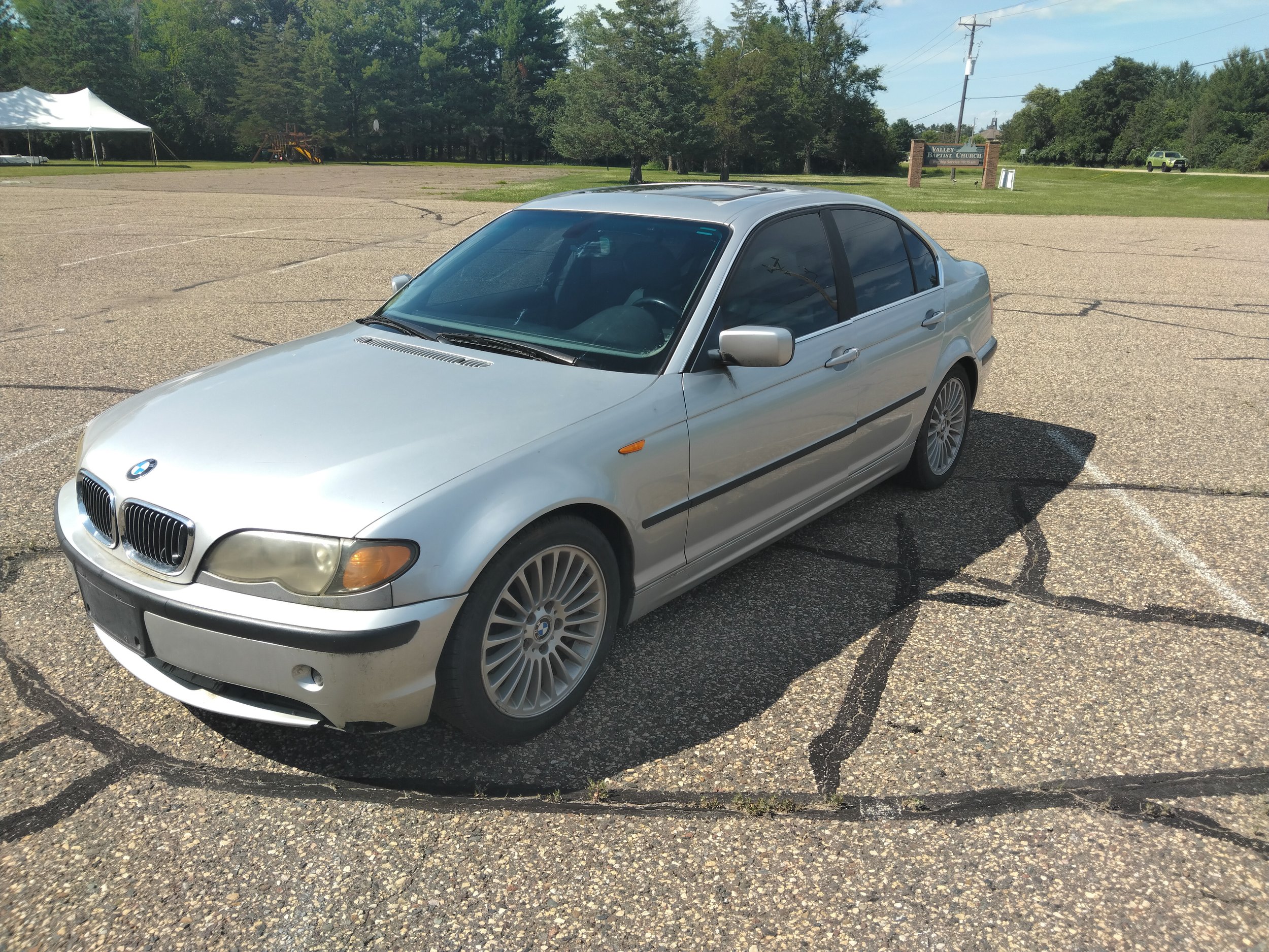 Silver BMW sedan nice driving vehicle