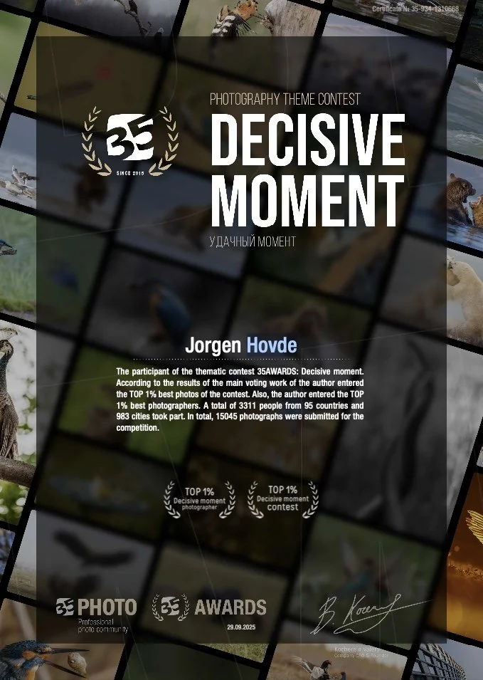Award certificate for the 35th Photography Theme Contest titled "Decisive Moment" awarded to Jorgen Hovde, recognizing his participation in the thematic contest with the winning photograph among a large number of submissions. The certificate features a collage of nature and wildlife photographs in the background.
