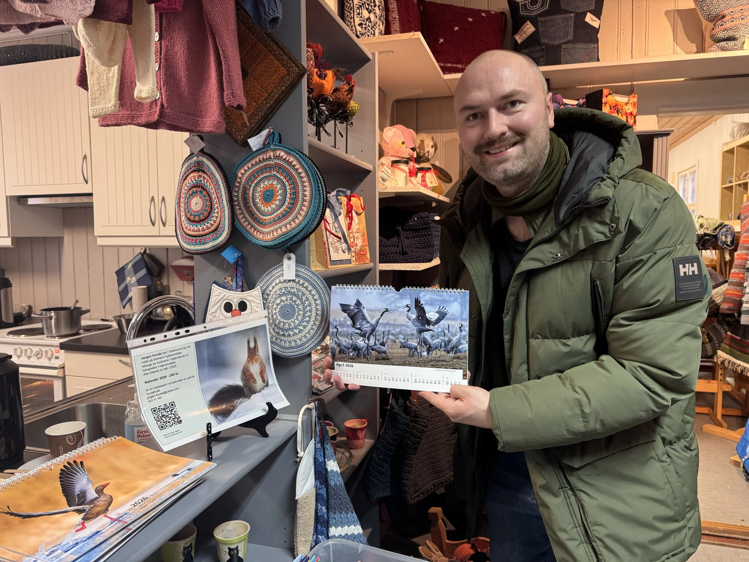 A picture of Jørgen Hovde in a shop posting with is calender