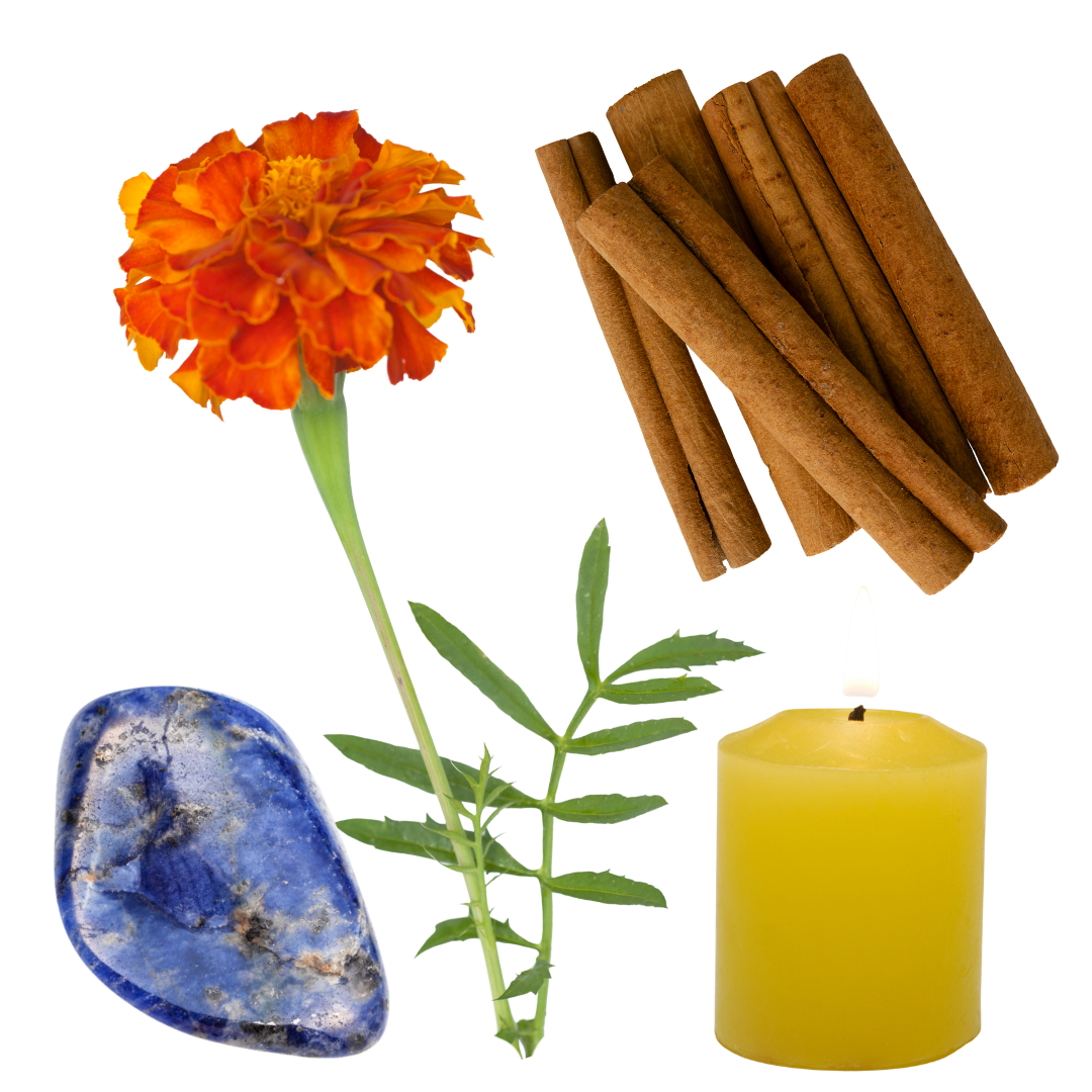 An arrangement of items including an orange marigold flower with green leaves, a stick of cinnamon, a yellow candle, and a blue sodalite stone.