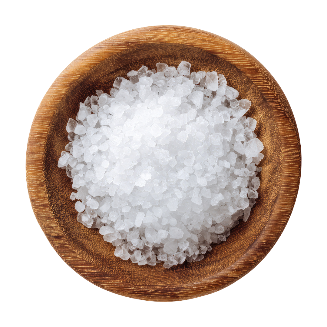 Sea salt gathered in a round wooden bowl.