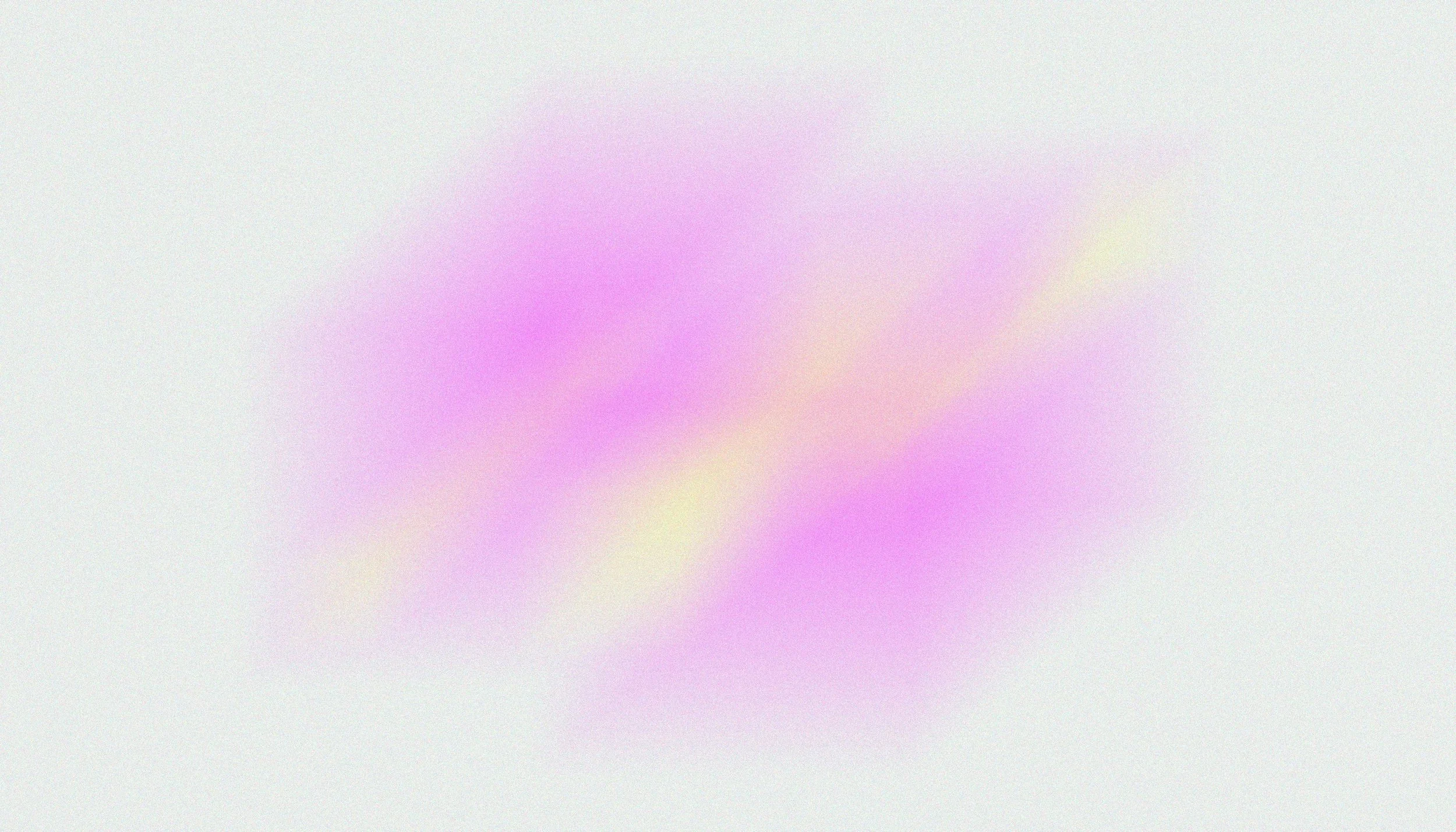 Blurred pastel-colored abstract background with pink, purple, and yellow hues.