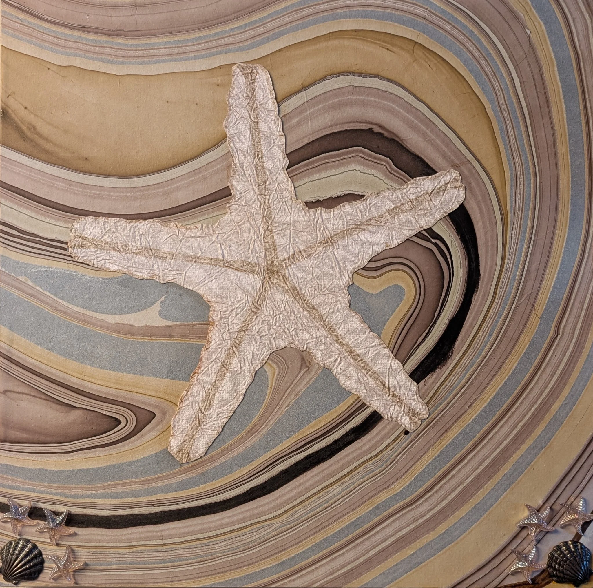 Tide Pool Treasures is a 16x16 mixed media collage created on board. Featuring a textured starfish on a marbled, wave-like background, this piece captures the quiet beauty of sea life and natural coastal elements. The soft earth tones and gentle flow
