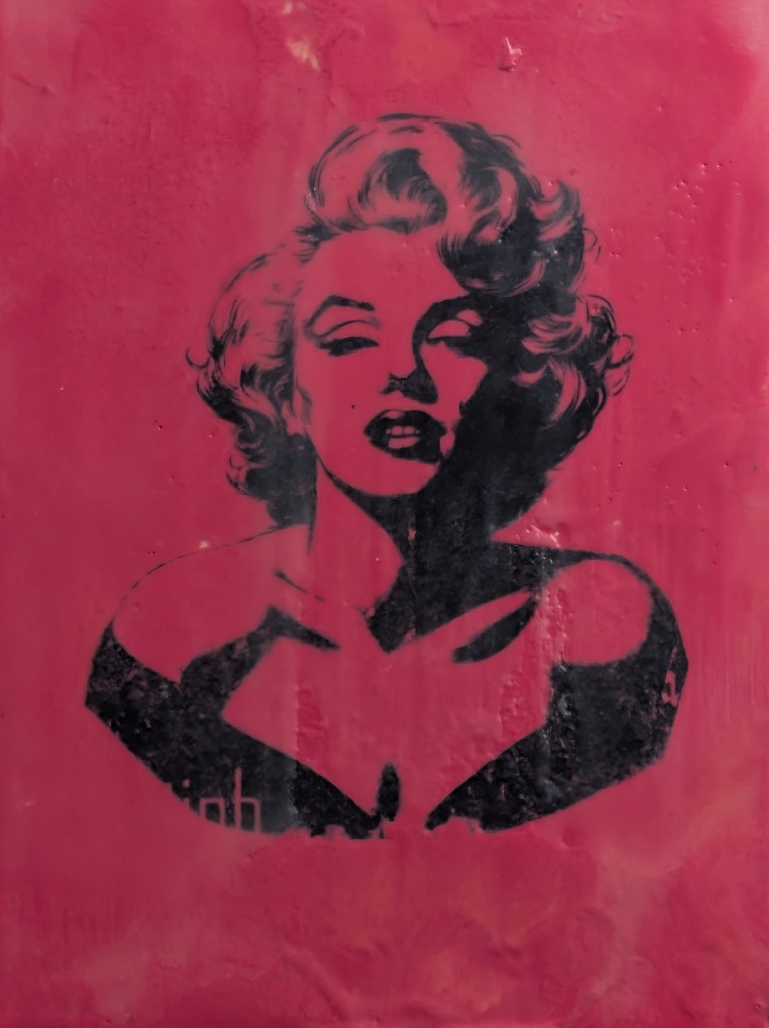 Stencil art of Marilyn Monroe with pink background.