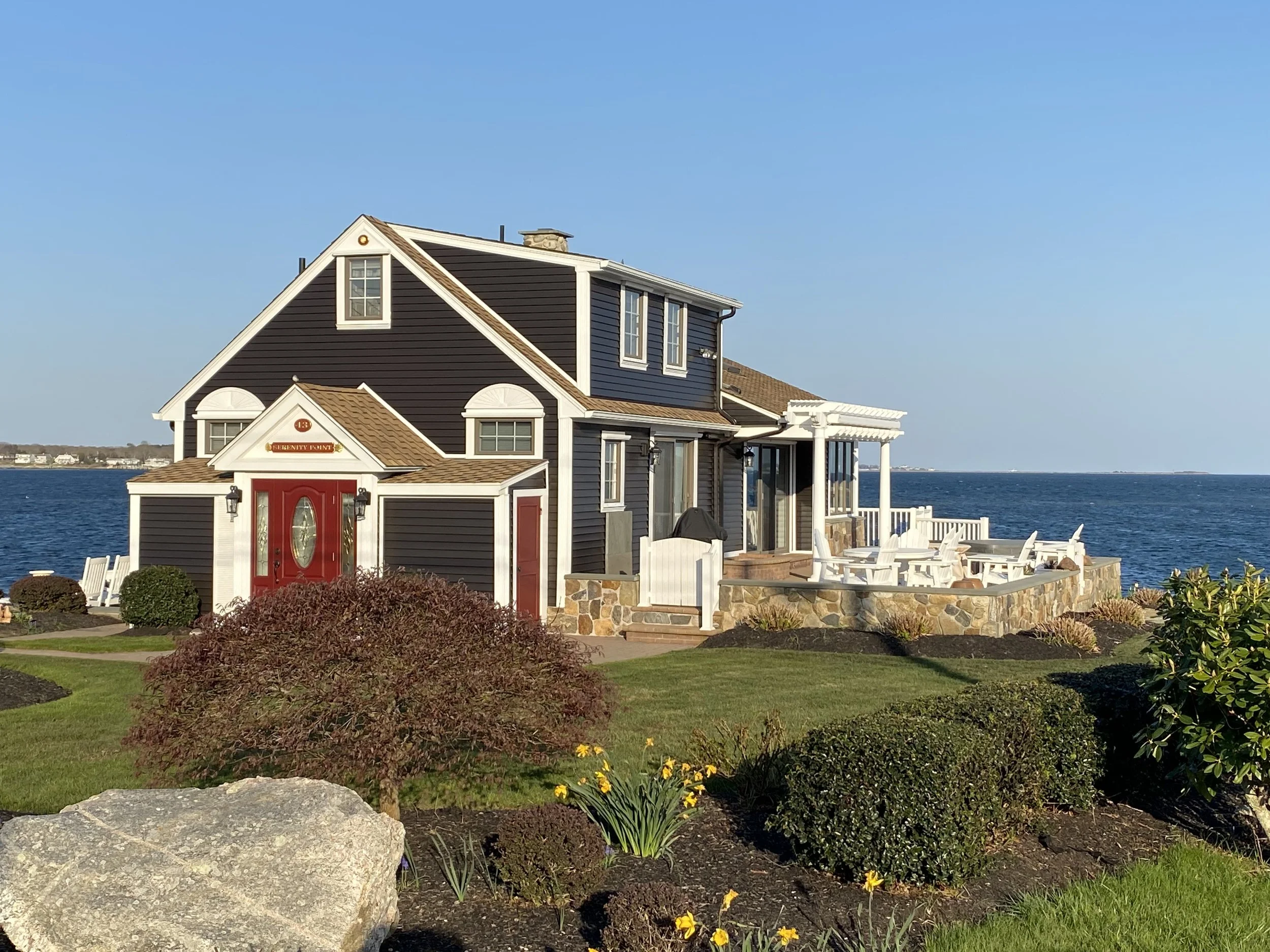 Exterior painting of waterfront home in Latimer Point, Stonington, Connecticut, by Cyr Painting and Restoration