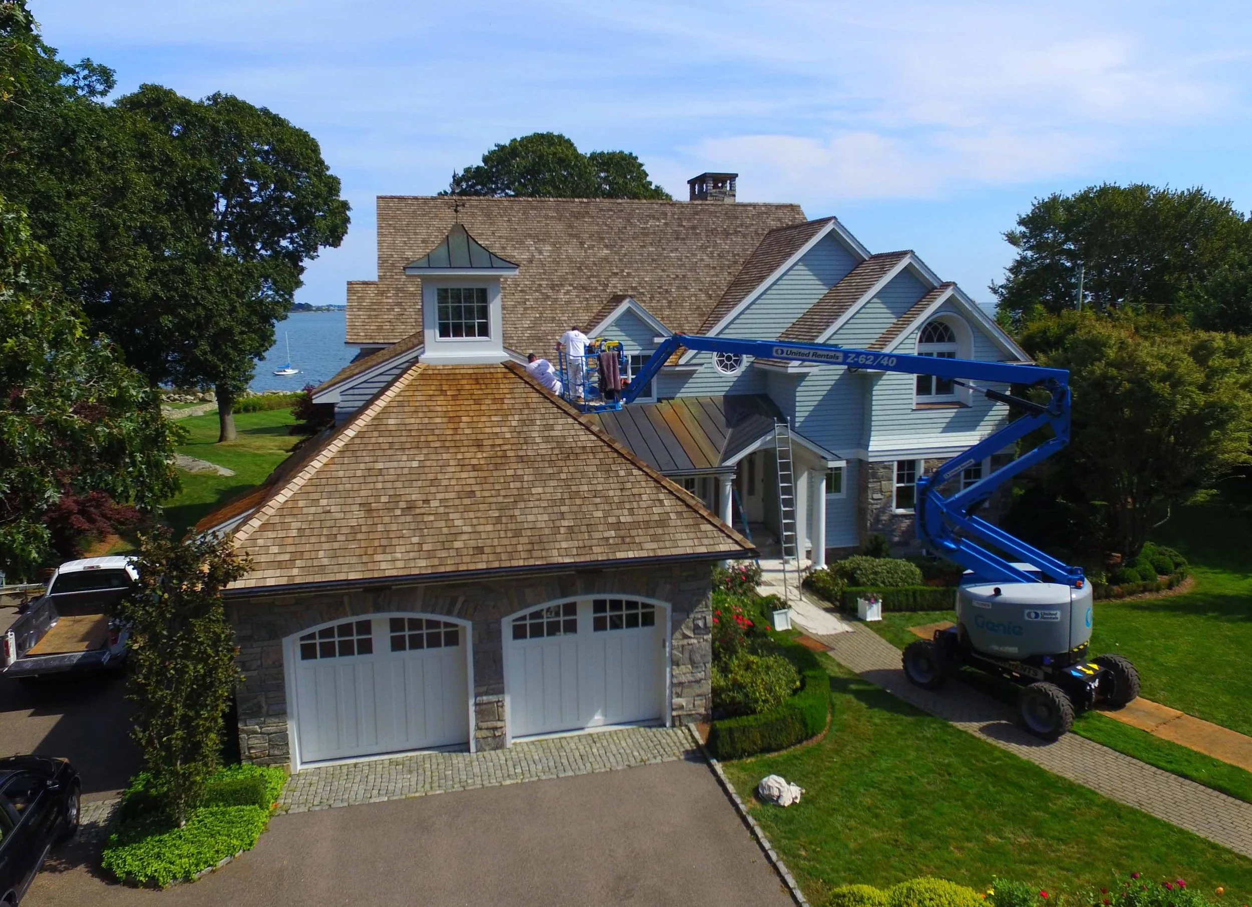 Roof restoration — cleaning and sealant application in progress.
