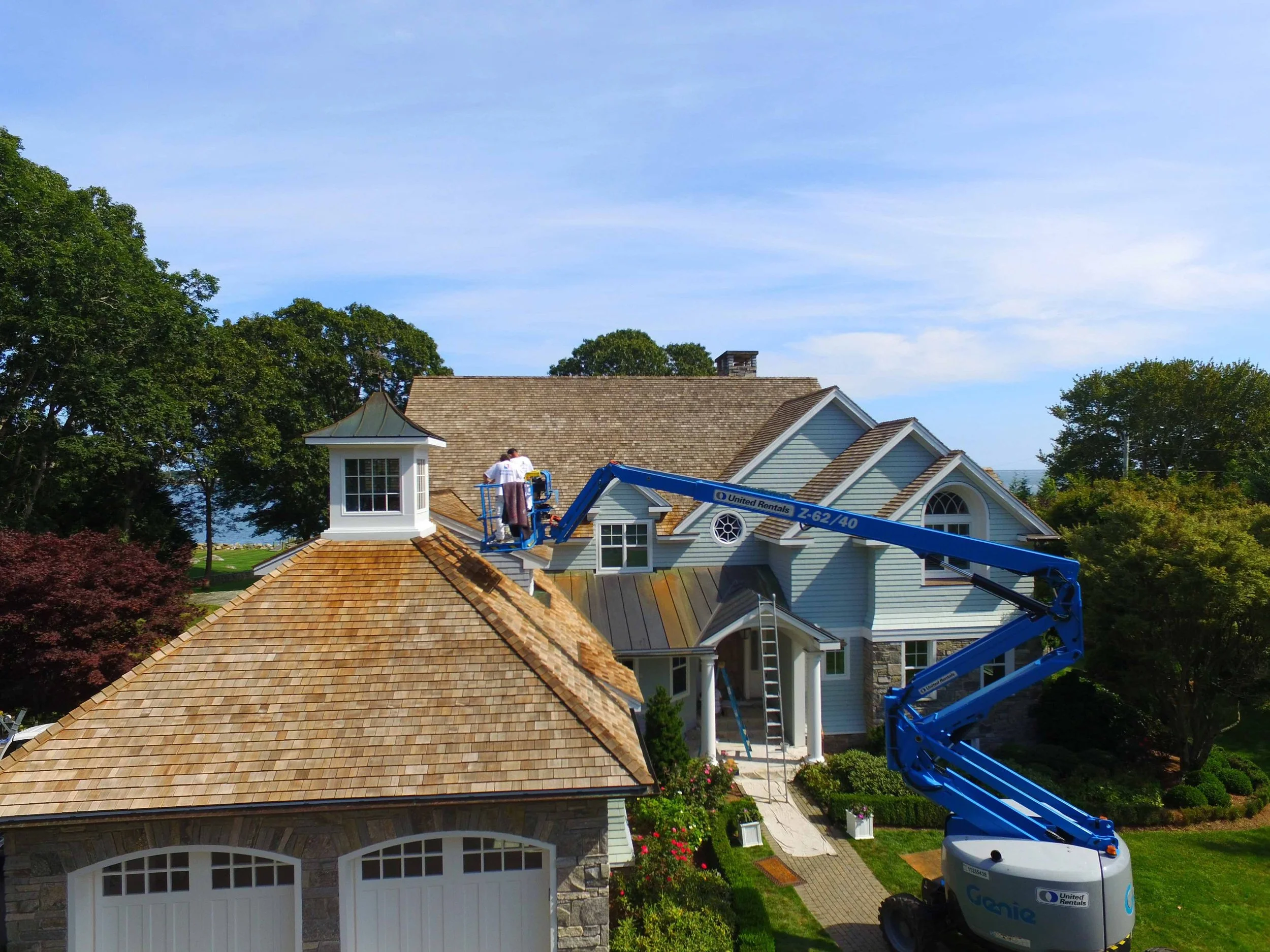 Roof restoration — cleaning and sealant application in progress.