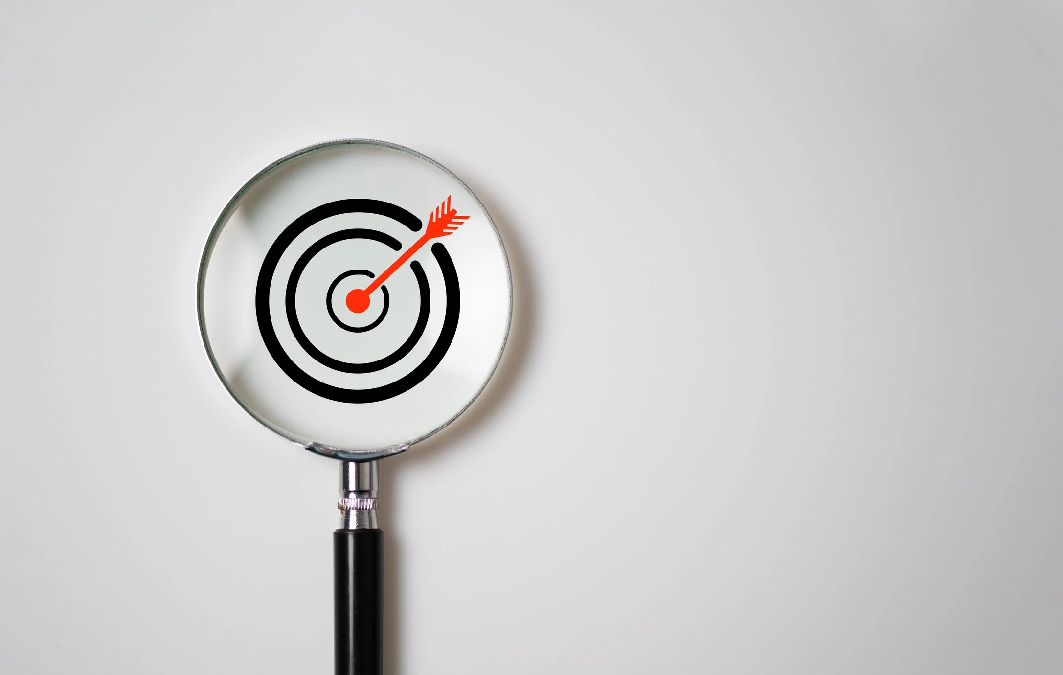A stethoscope with a target and arrow design on the diaphragm, resembling a bullseye with an arrow hitting the center.
