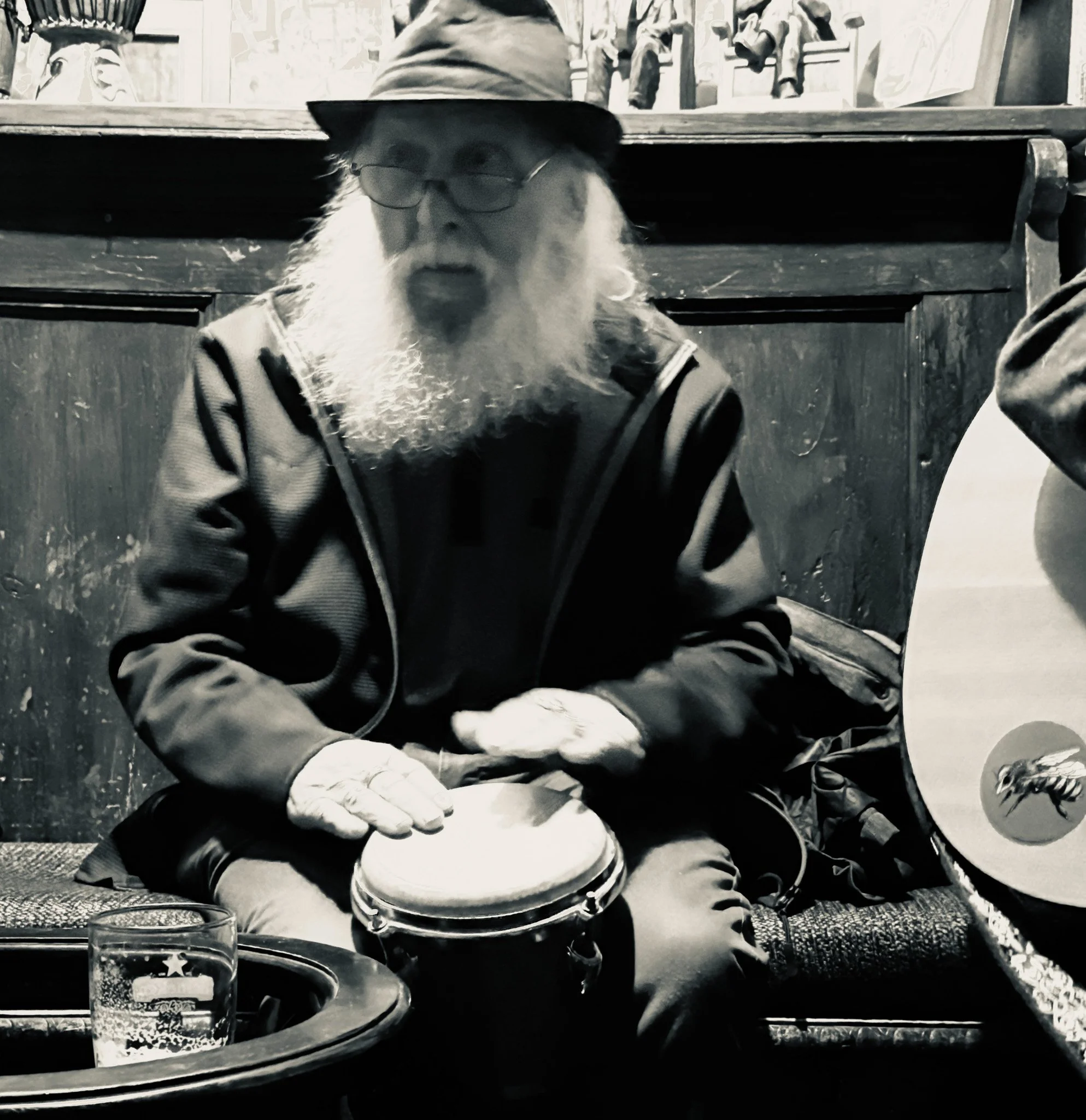 Old man playing bongos
