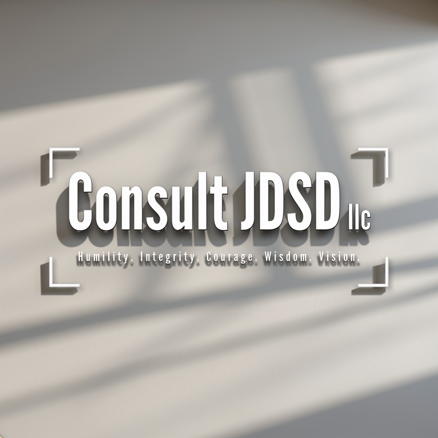 Text on a wall reading "Consult JDSD LLC" with the words "Humility. Integrity. Courage. Wisdom. Vision." below.